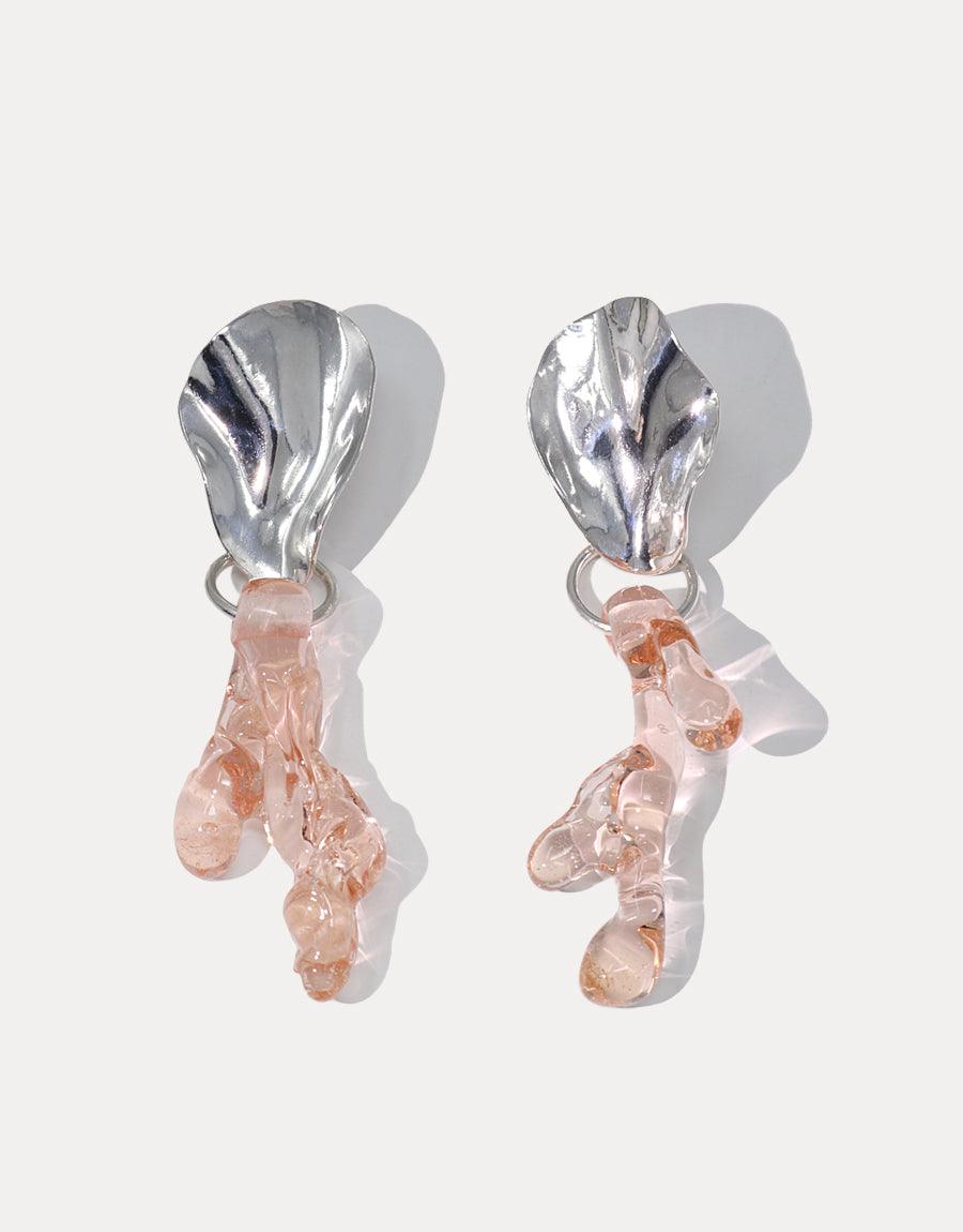 Elegant Coral Reef Earrings featuring silver wavy tops and delicate pink eco-glass coral-shaped pendants, showcasing sustainable artistry and ocean-inspired design. Handcrafted statement jewelry by CLED, perfect for eco-conscious fashion lovers. Coral Reef Earrings by CLED.