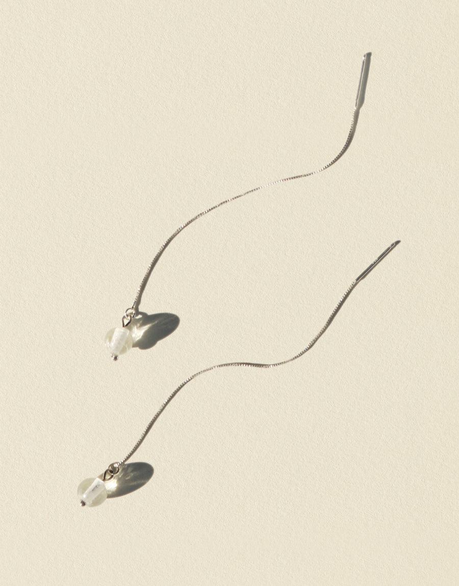 Elegant Minimal Line Earrings featuring delicate silver chains with small suspended glass Eco Gems. Sleek, modern design for everyday wear. Handcrafted, sustainable jewelry showcasing repurposed glass. Ethically made in Los Angeles. Minimal Line Earrings by CLED.