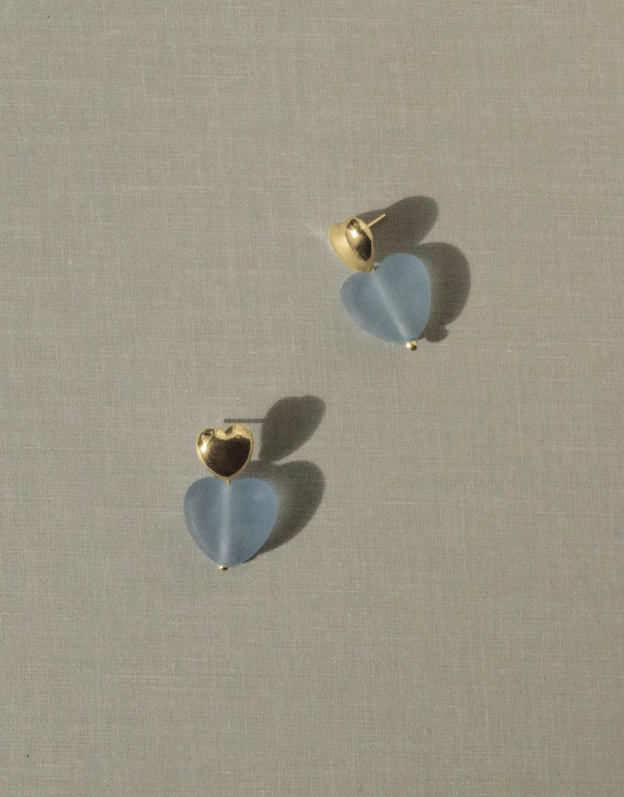 Elegant Love Earrings with Large Heart Drop featuring matte blue jay glass hearts and gold vermeil studs, showcasing eco-friendly design and handcrafted artistry. Sterling silver components. Sustainably made in Los Angeles. CLED