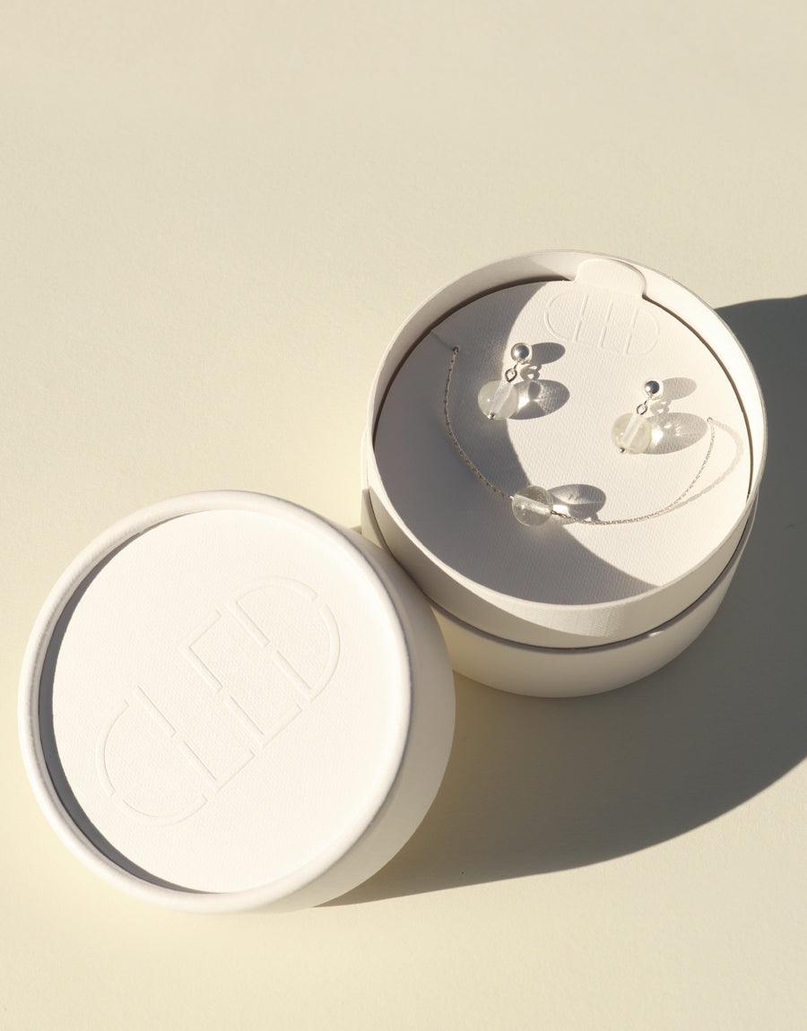 Minimal Ball Earrings | Small displayed in elegant white circular jewelry box, showcasing delicate sterling silver design with eco-friendly glass gems. Handcrafted sustainable jewelry by CLED
