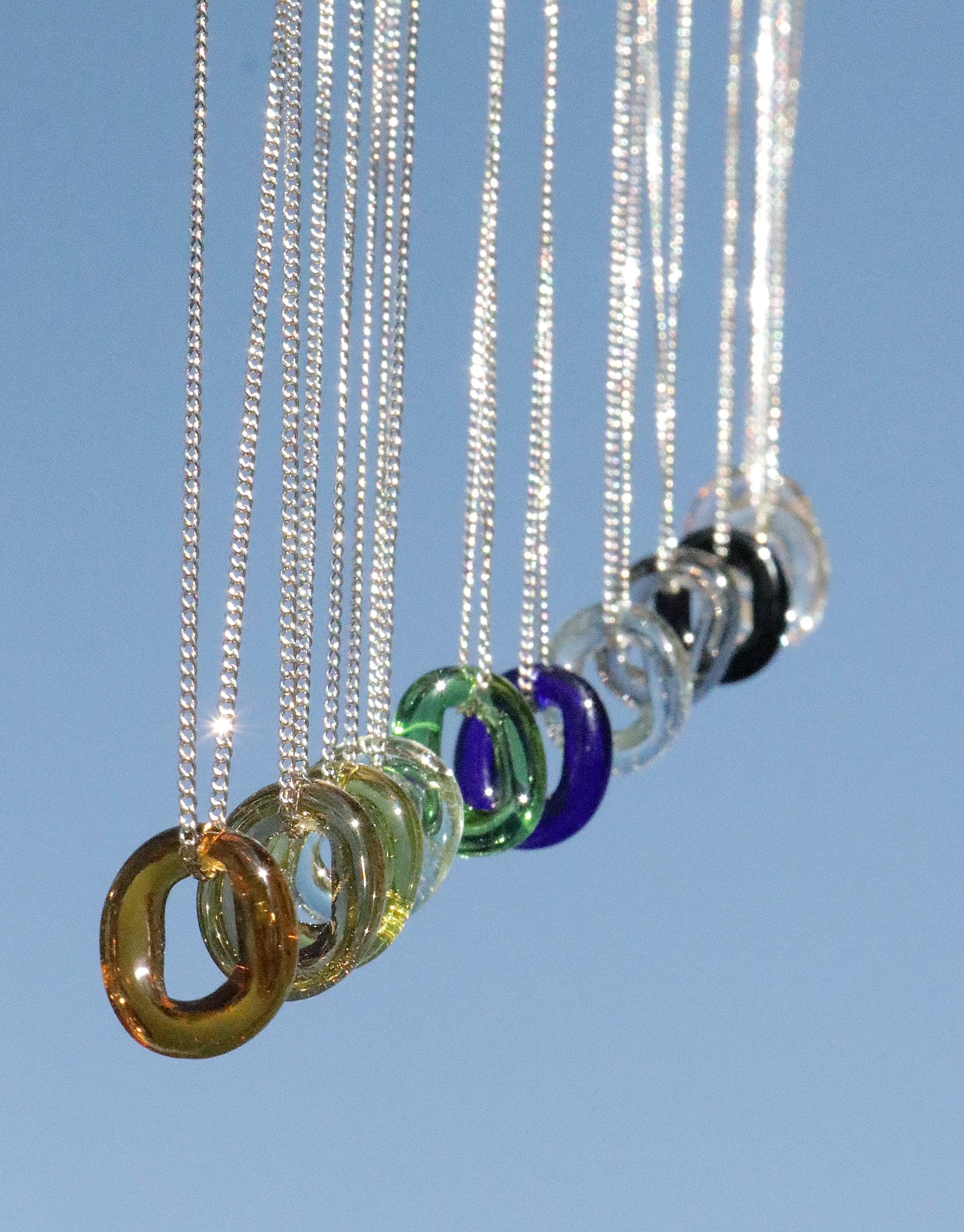 Elegant In The Loop Necklace featuring colorful eco-friendly glass pendants on delicate silver chains. Minimal design with sustainable repurposed glass in various hues, showcasing CLED's commitment to eco-conscious jewelry. Perfect for everyday wear or special occasions. CLED
