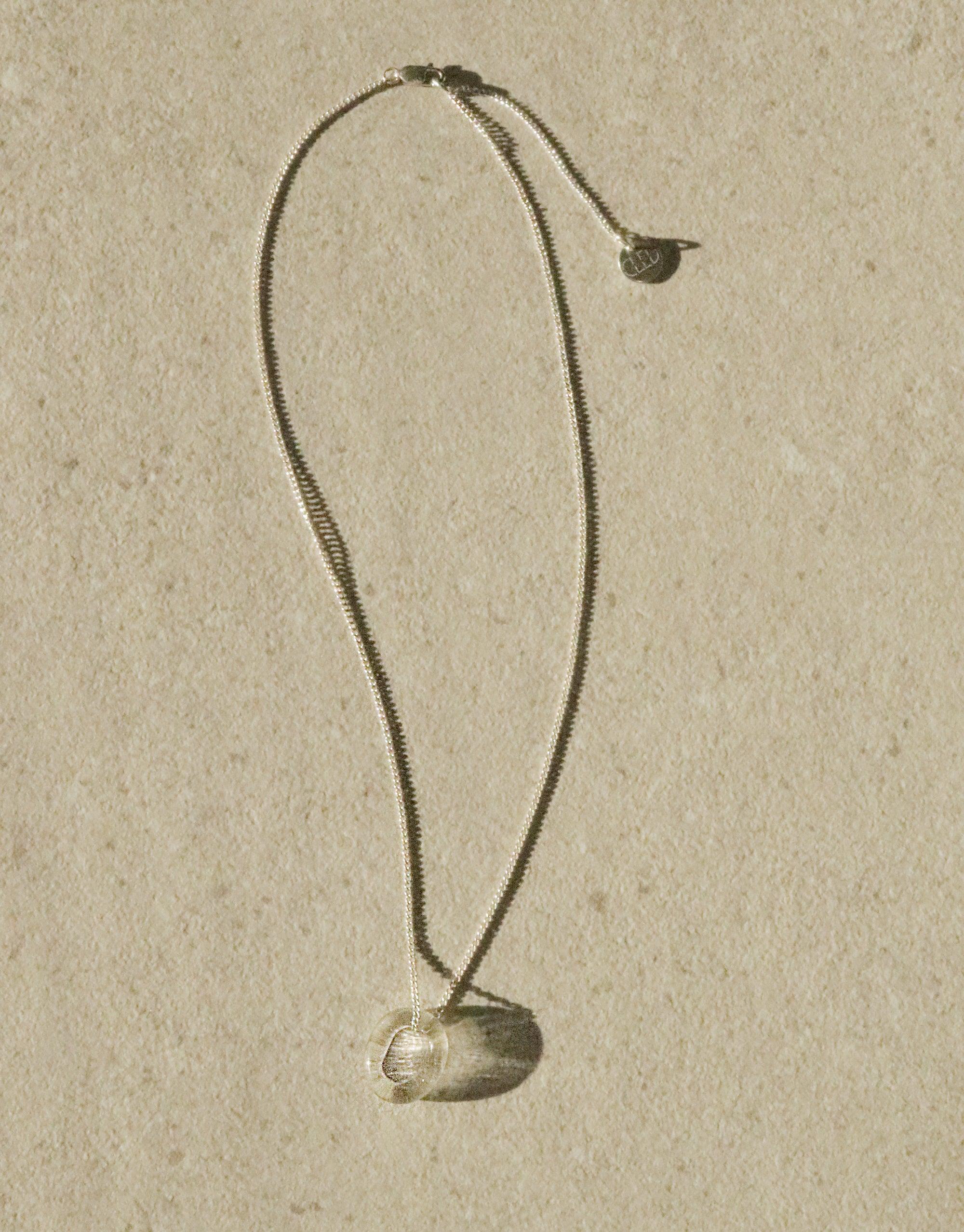 Elegant In The Loop Necklace featuring a delicate curb chain and minimalist eco-friendly glass pendant, showcasing sustainable luxury in a sleek design. Adjustable length for versatile styling. Handcrafted with care by CLED.