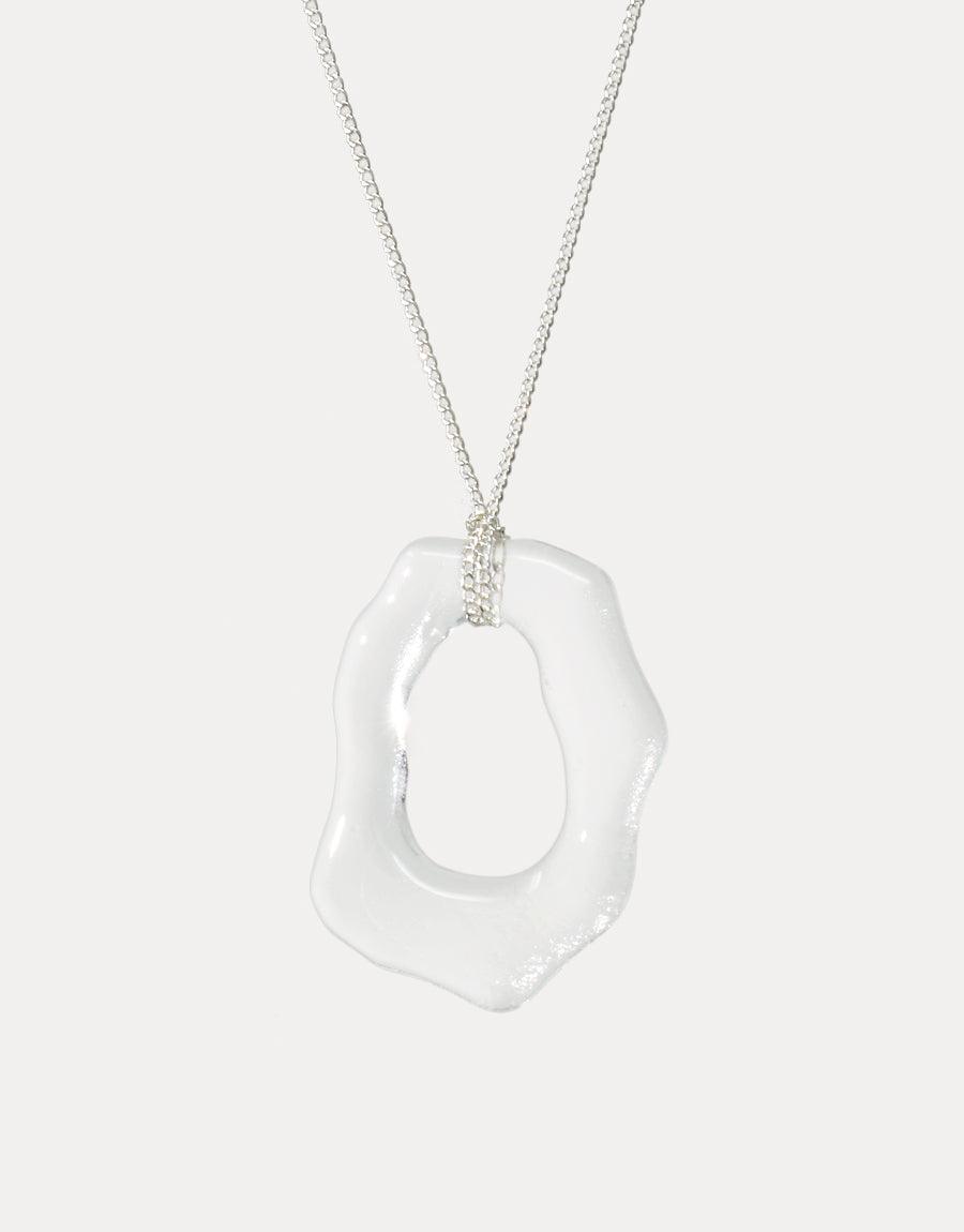 Sterling silver necklace with unique, organic-shaped clear glass pendant. High Tide Necklace features a repurposed eco gem from discarded bottles, showcasing sustainable elegance. Handcrafted ocean-inspired design by CLED.