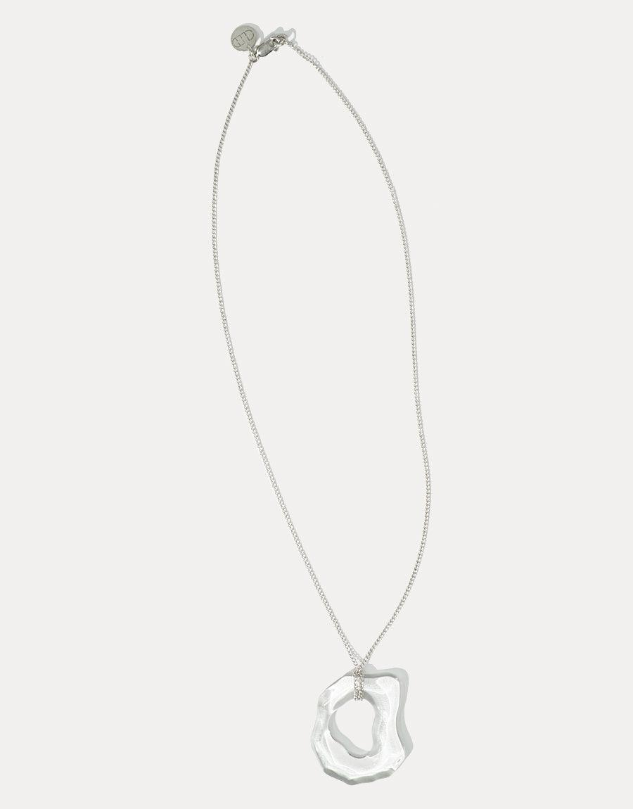 High Tide Necklace featuring a delicate silver chain with an organic, wave-inspired pendant. The unique, translucent pendant is handcrafted from eco-friendly recycled glass. Elegant and sustainable jewelry piece by CLED.