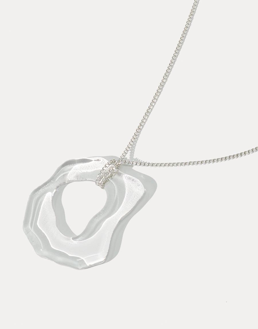 High Tide Necklace featuring an organic, wave-inspired pendant made from repurposed glass. Sterling silver chain showcases eco-friendly craftsmanship. Elegant, ocean-themed jewelry perfect for layering. Handmade in Los Angeles. CLED