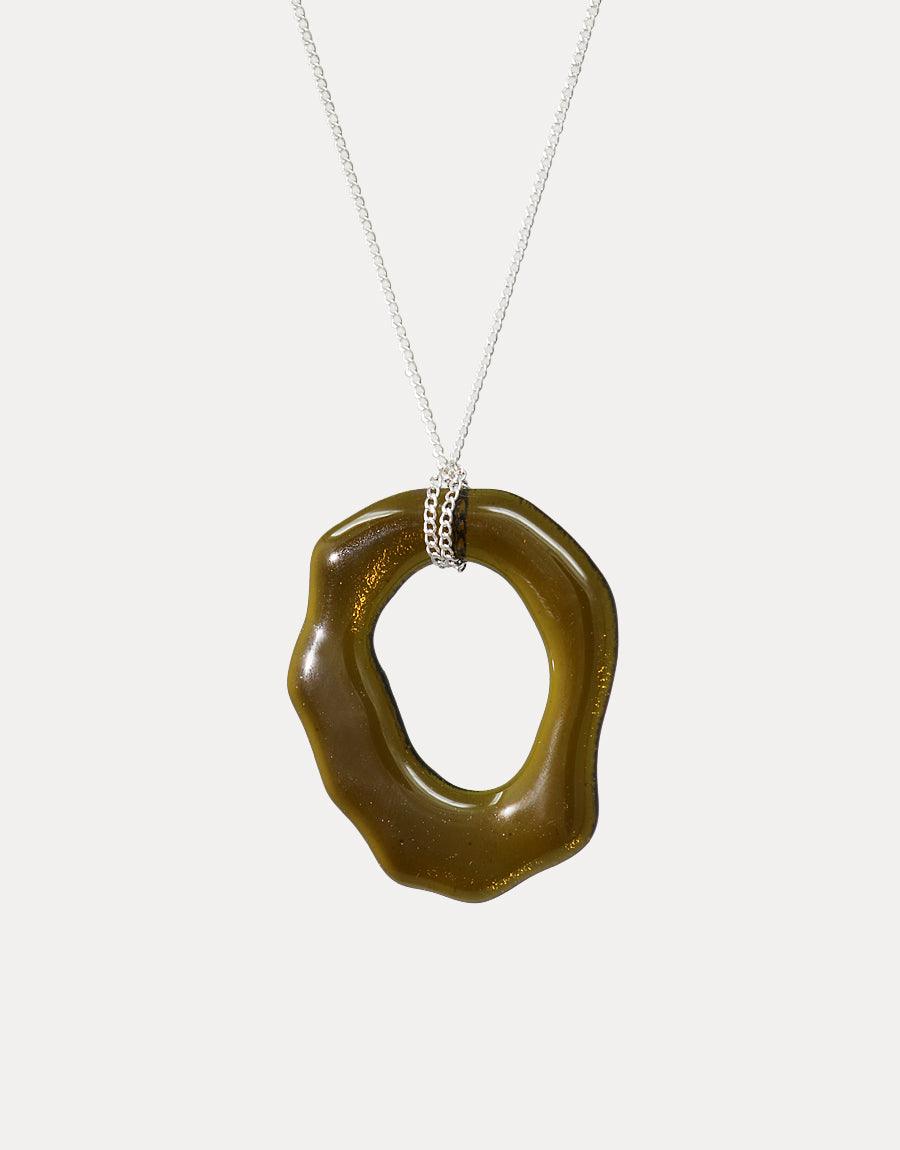 High Tide Necklace featuring a unique, olive-green organic pendant made from repurposed glass bottles. Sterling silver chain with an eco-friendly, ocean-inspired design. Handcrafted, sustainable jewelry by CLED.