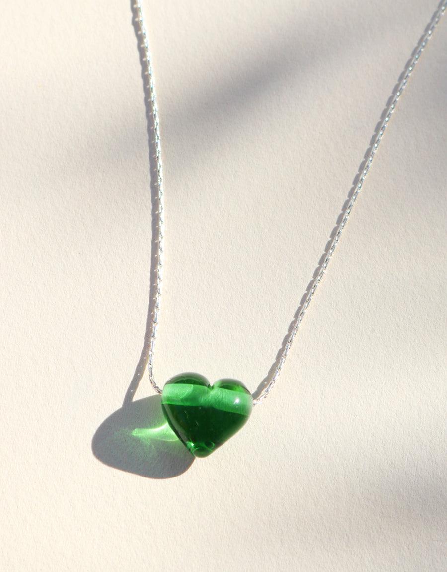Love Necklace featuring a delicate silver chain with a vibrant green glass heart pendant. Handcrafted recycled glass charm symbolizing love and sustainability. Elegant and eco-friendly jewelry piece by CLED.