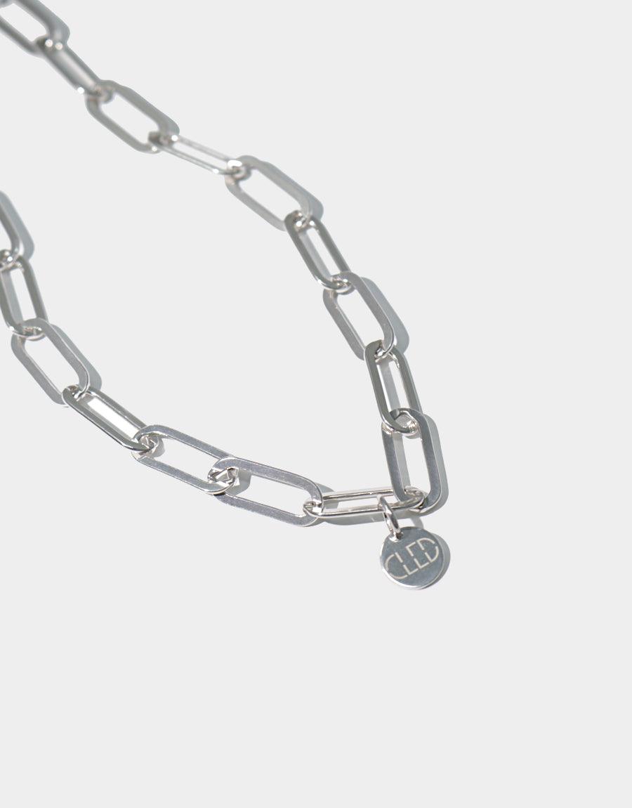 Sterling silver oval chain necklace with elongated links and a small circular pendant, showcasing sleek modern design. Handcrafted jewelry piece featuring a minimalist aesthetic, perfect for everyday wear. Opening Necklace by CLED