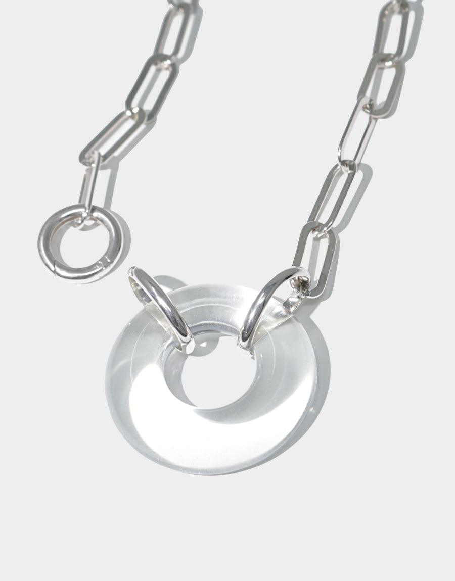 Elegant Opening Necklace featuring a circular glass pendant on a sterling silver oval chain. Handcrafted from repurposed glass, this edgy and distinct piece showcases sustainable luxury. Made in Los Angeles by CLED.