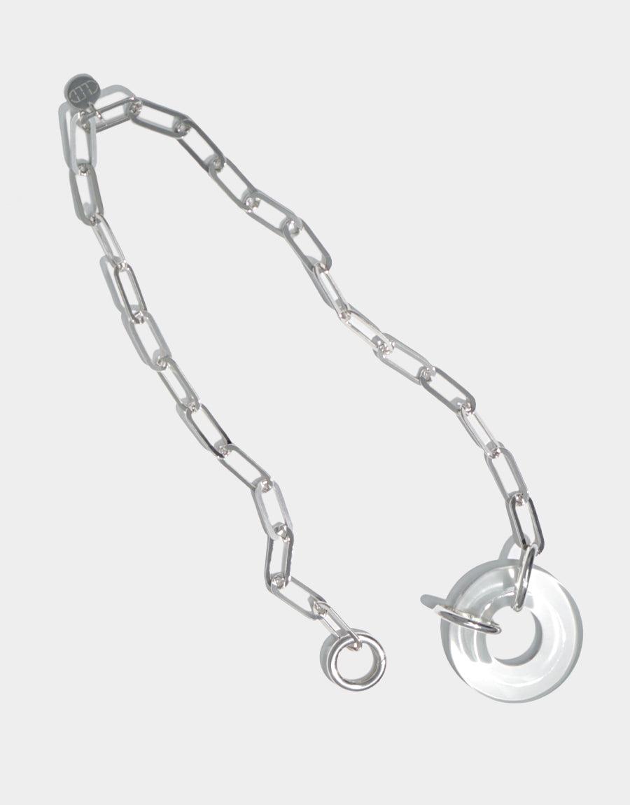 Sterling silver Opening Necklace featuring a sleek oval chain with a distinctive circular glass pendant. Handcrafted design showcasing sustainable, repurposed materials. Elegant and modern accessory for a sophisticated look. CLED Opening Necklace.