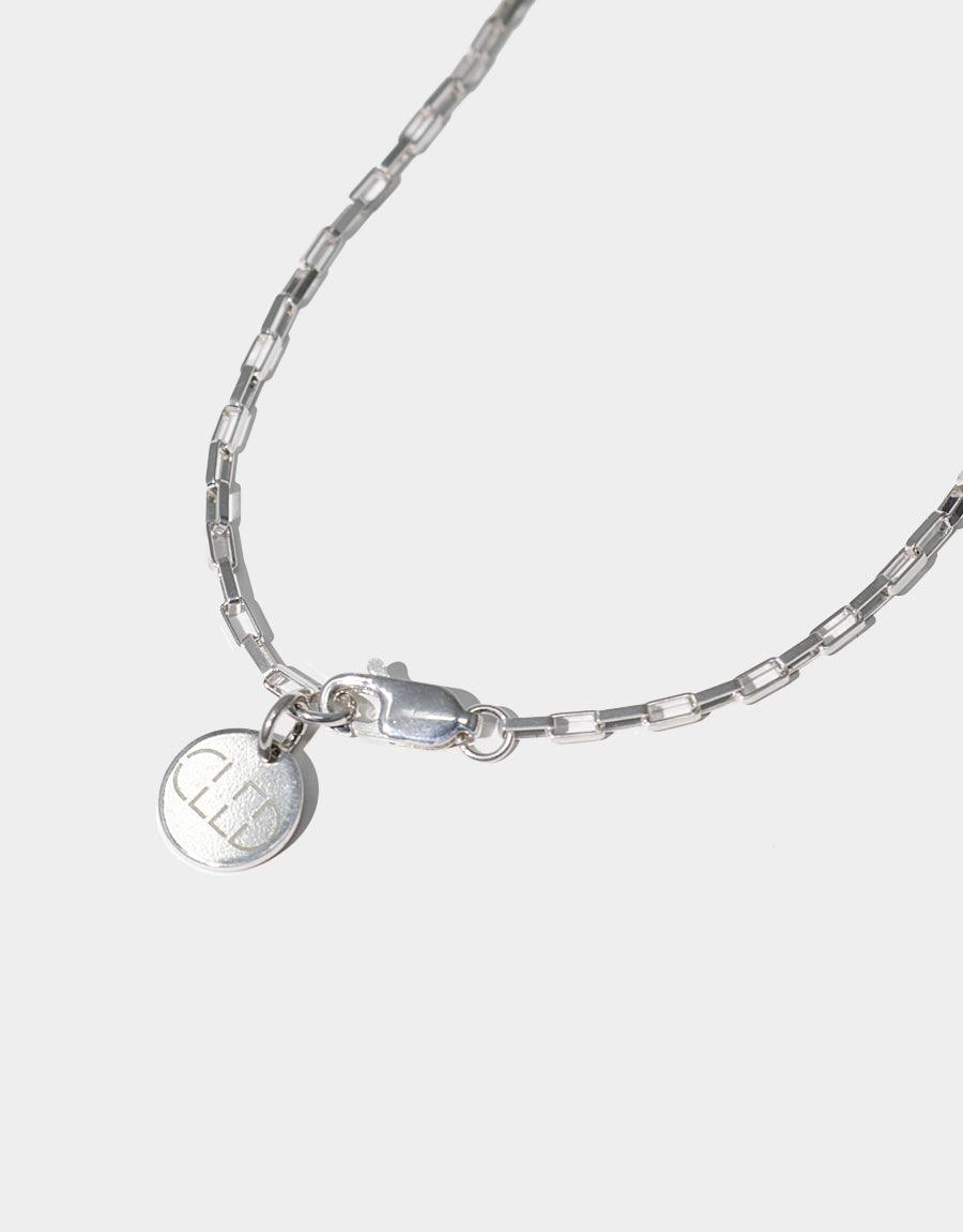 Elegant sterling silver square cable chain necklace with a small circular pendant, showcasing the Natural Pearl Necklace's delicate design. Handcrafted with recycled materials, this versatile piece adds a touch of sophistication to any outfit. CLED