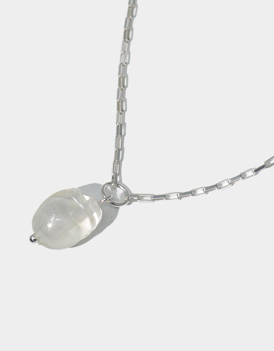 Natural Pearl Necklace featuring a single semi-transparent white glass pearl pendant on a delicate silver chain. Elegant, minimalist design showcasing recycled materials. Handcrafted sustainable jewelry perfect for everyday wear. CLED Natural Pearl Necklace.