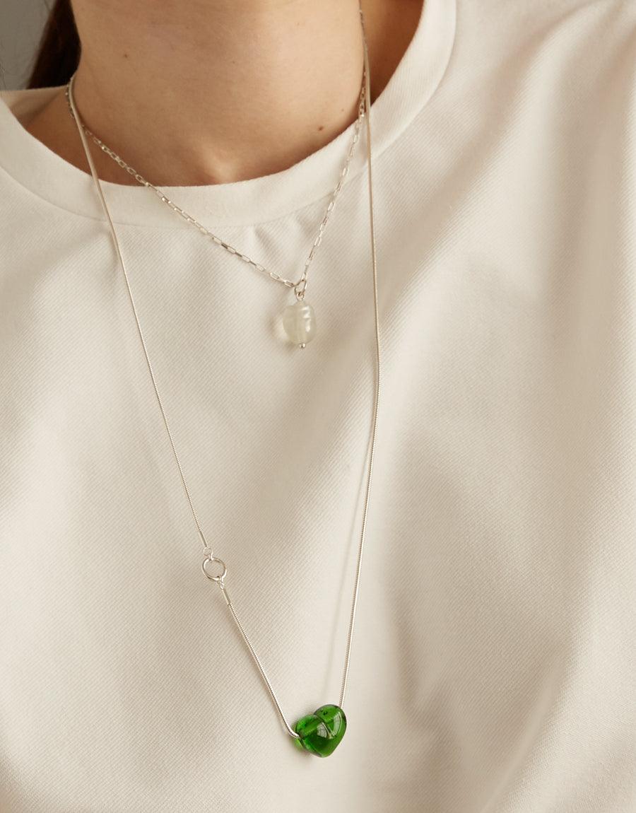 Elegant Natural Pearl Necklace with white recycled glass pearl and green pendant on sterling silver chains, showcasing sustainable jewelry craftsmanship. Versatile accessory for everyday wear, embodying eco-conscious style. CLED Natural Pearl Necklace.