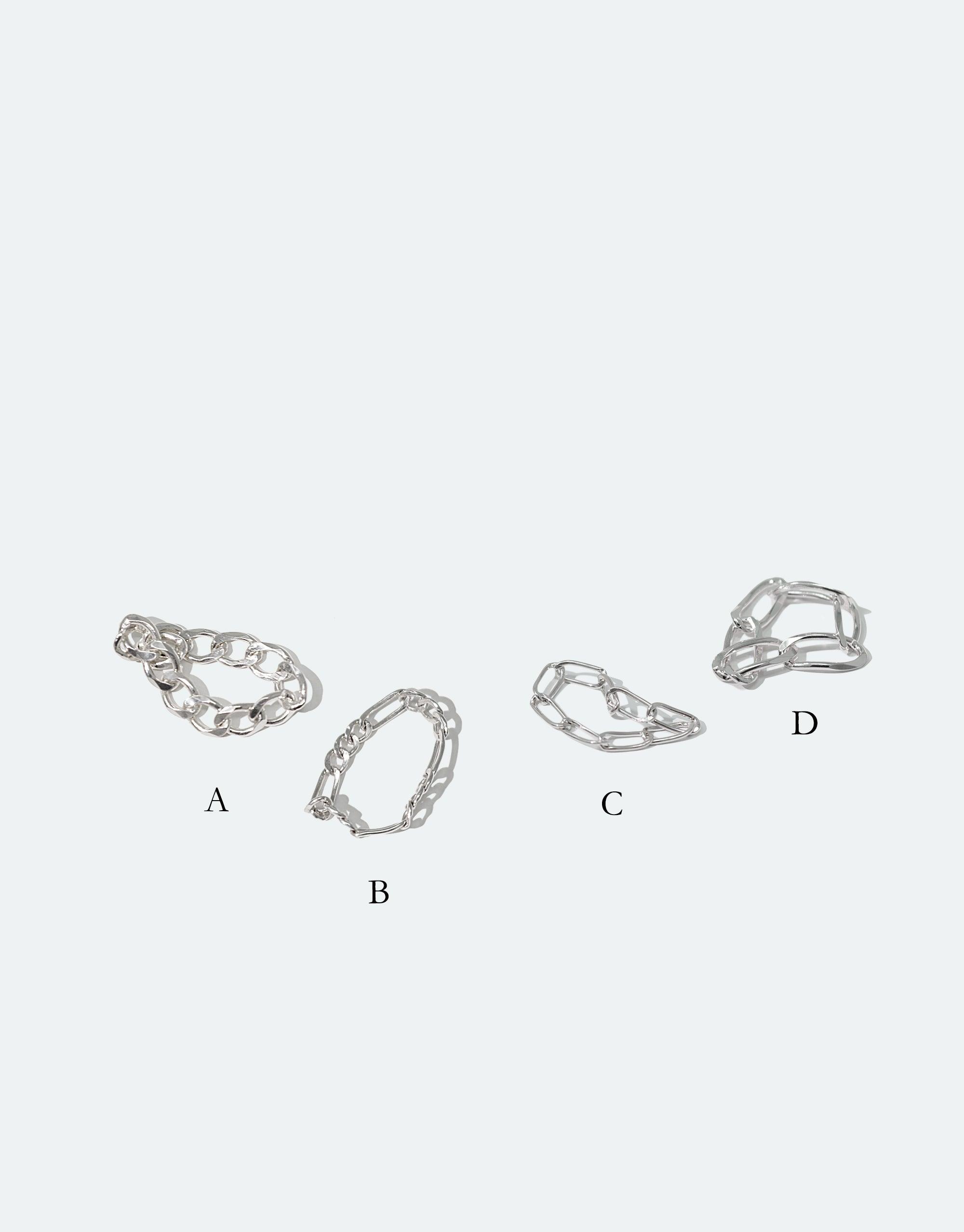 Four sterling silver collapsible chain rings in different styles labeled A, B, C, and D, showcasing unique open-link designs. Handcrafted in Los Angeles, these versatile rings can be reshaped and mixed with other jewelry. Collapsible Chain Ring | D by CLED