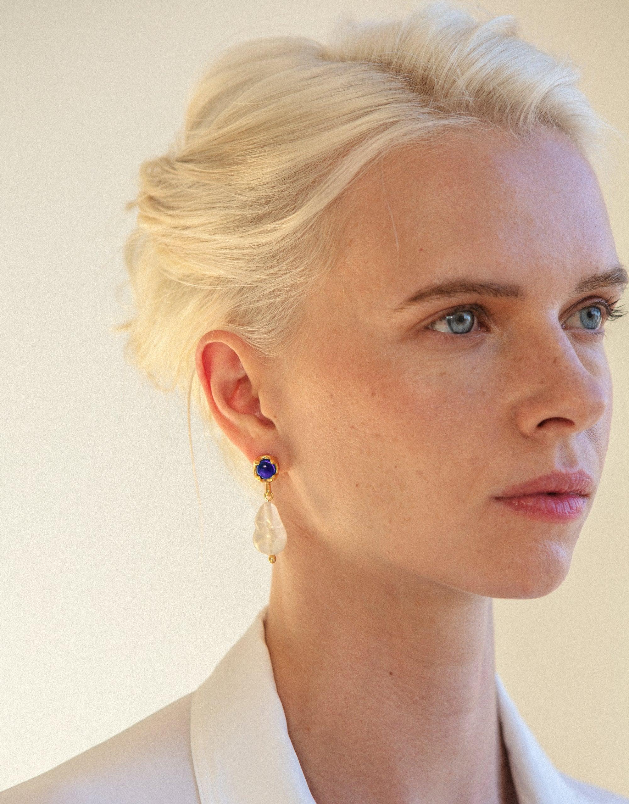 Close-up profile view showcasing Beam Pearl Earrings, featuring a blue gemstone stud and a translucent drop pendant. Elegant design highlighting the eco-friendly, handcrafted nature of CLED jewelry.