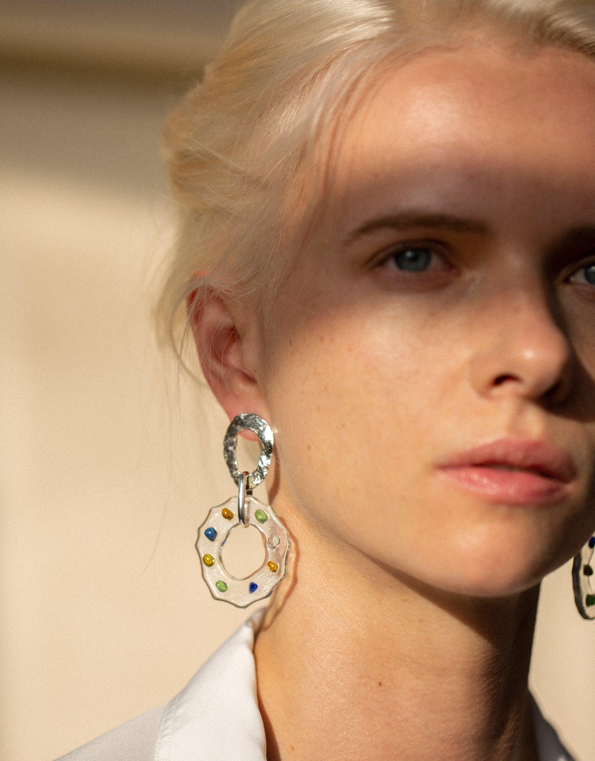 Close-up of High Tide Earrings in Spectrum, featuring circular design with colorful eco gems upcycled from glass. Sterling silver earrings showcasing prismatic colors, handmade in Los Angeles. Sustainable jewelry by CLED.