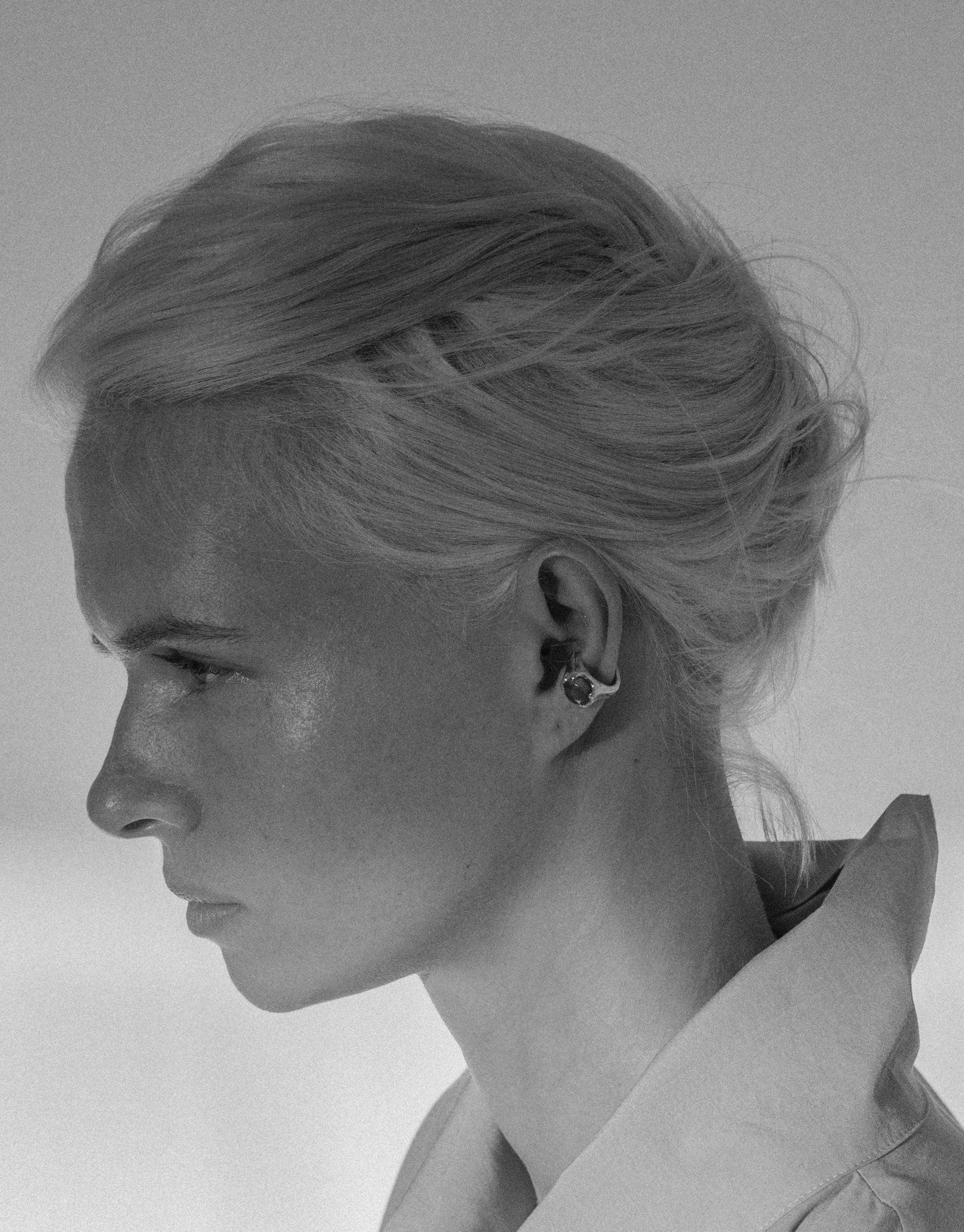 Profile view of a person wearing the Beam Ear Cuff, showcasing the unique design and elegant styling of this handcrafted jewelry piece. The earring's intricate details are visible, highlighting the craftsmanship of CLED's Beam Ear Cuff.