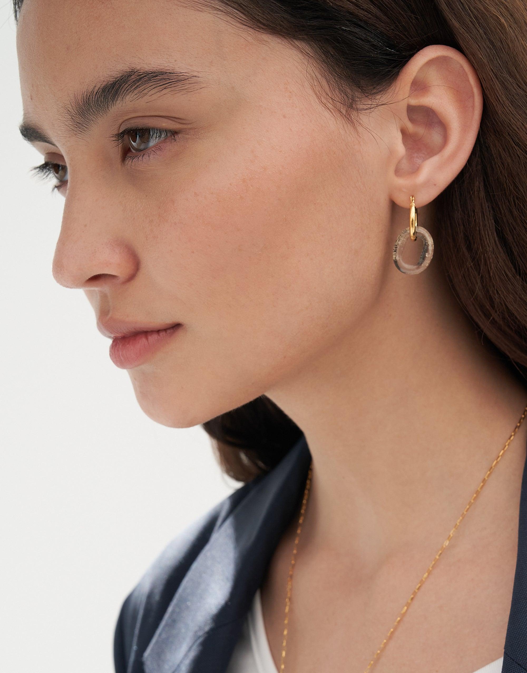 Elegant model wearing In The Loop Hoops | Small, featuring minimalist gold hoop earrings with a signature eco gem loop. Showcases the earring's delicate design and repurposed glass aesthetic. Sustainable jewelry by CLED.