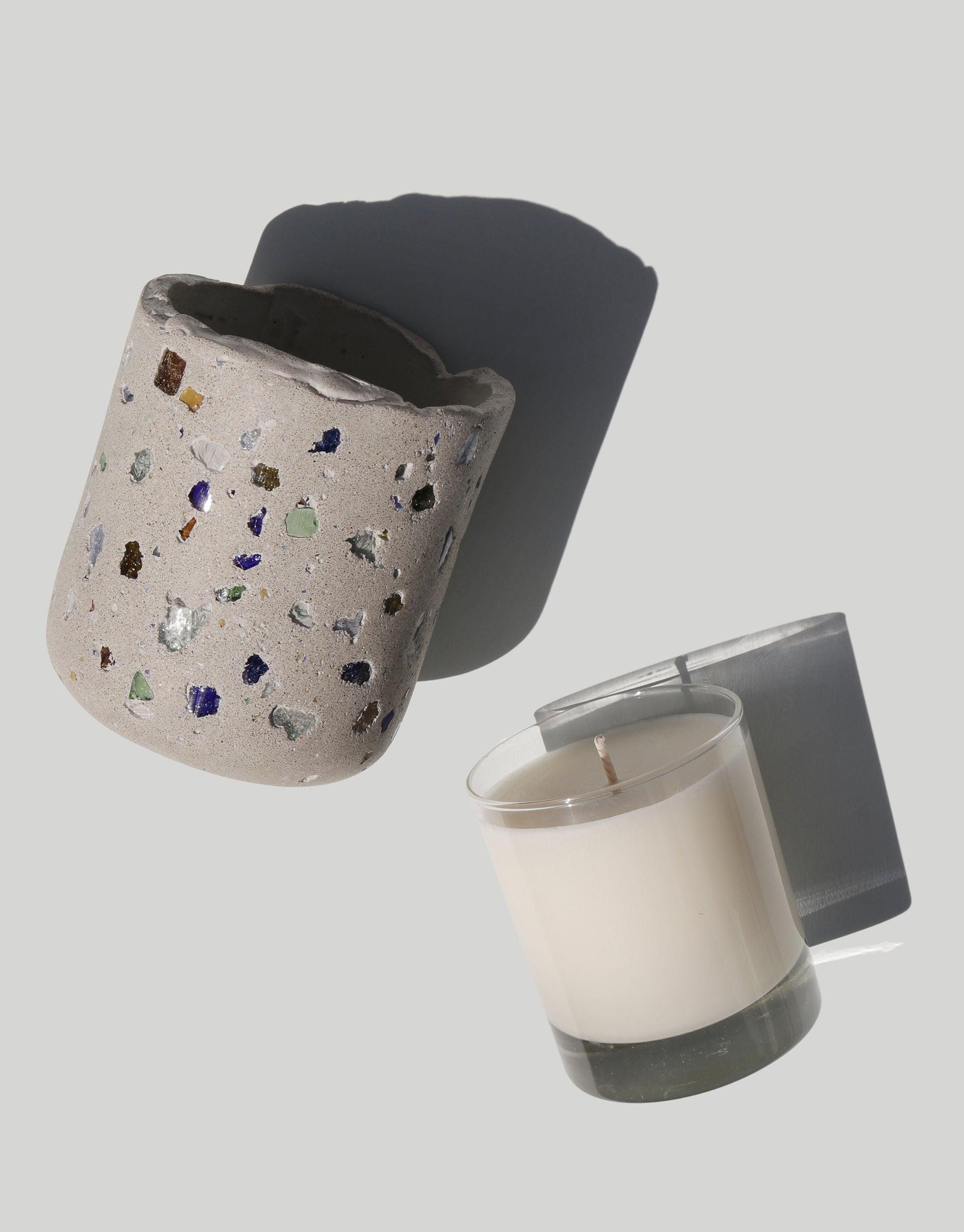 Handcrafted concrete vessel with colorful recycled glass terrazzo pattern and soy wax candle in glass container, showcasing sustainable design collaboration for LAIT X SHIPPE X CLED Vessel & Candle product. CLED