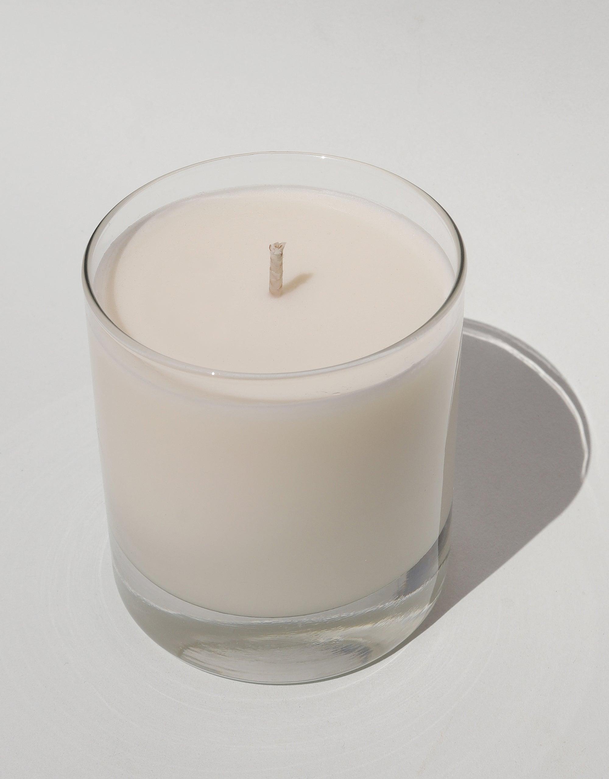 LAIT X SHIPPE X CLED Vessel & Candle featuring a glass container with white soy wax candle and cotton wick. Minimalist design showcasing handcrafted, eco-friendly materials for sustainable home decor and aromatherapy. Collaborative product emphasizing upcycling and circular design. CLED