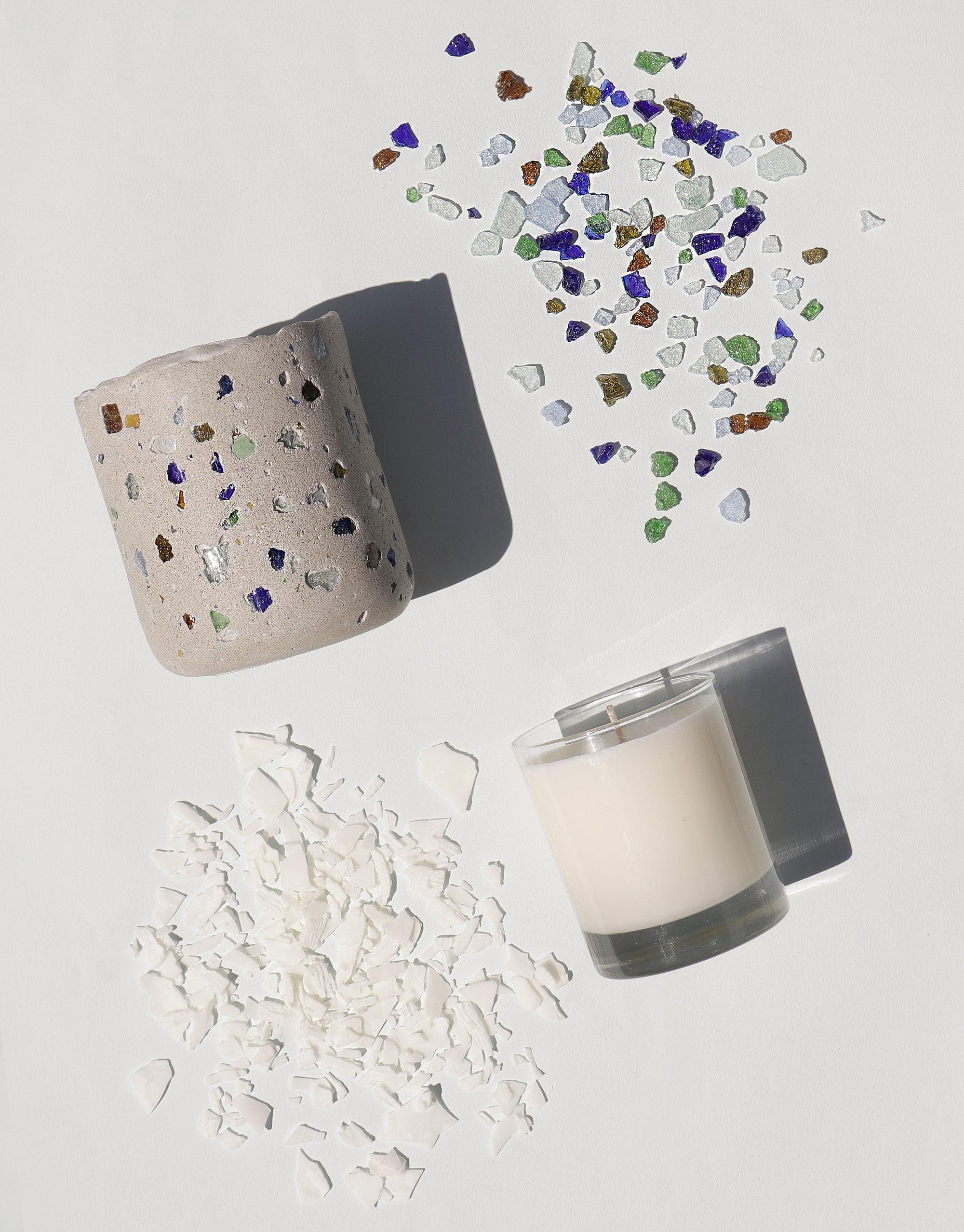 Handcrafted concrete vessel with colorful recycled glass pieces, soy candle, and raw materials showcasing the LAIT X SHIPPE X CLED Vessel & Candle collaboration, emphasizing sustainability and artisanal craftsmanship CLED