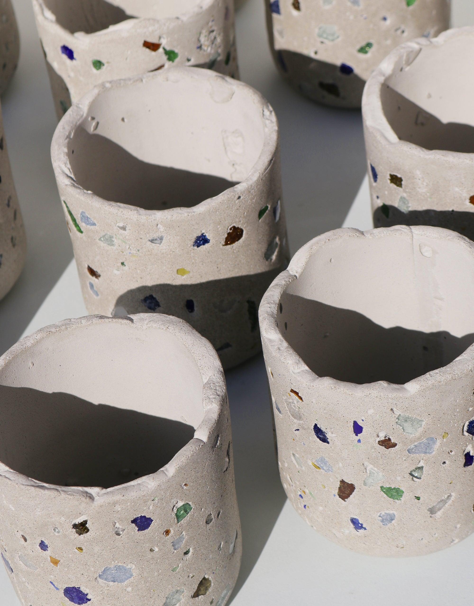 Handcrafted concrete vessels with colorful recycled glass terrazzo pattern for LAIT X SHIPPE X CLED Vessel & Candle. Sustainable, unique containers for eco-friendly soy candles. Circular collaboration showcasing upcycled materials. CLED