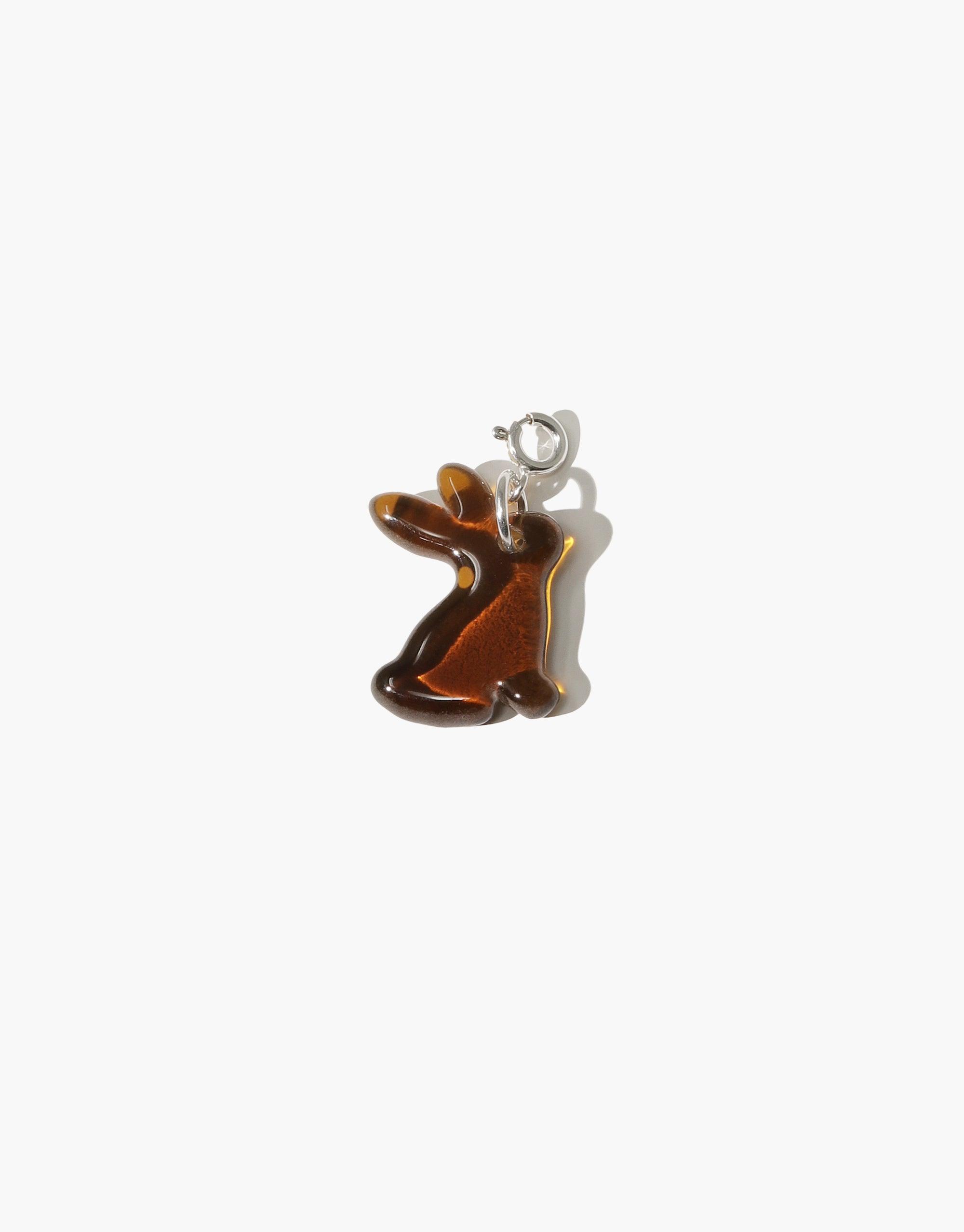 Stylish amber-colored rabbit charm made from upcycled glass, featuring a sleek silhouette and silver attachment. Handcrafted Lunar New Year accessory for Year of the Rabbit celebrations. Rabbit | Icon Charm by CLED