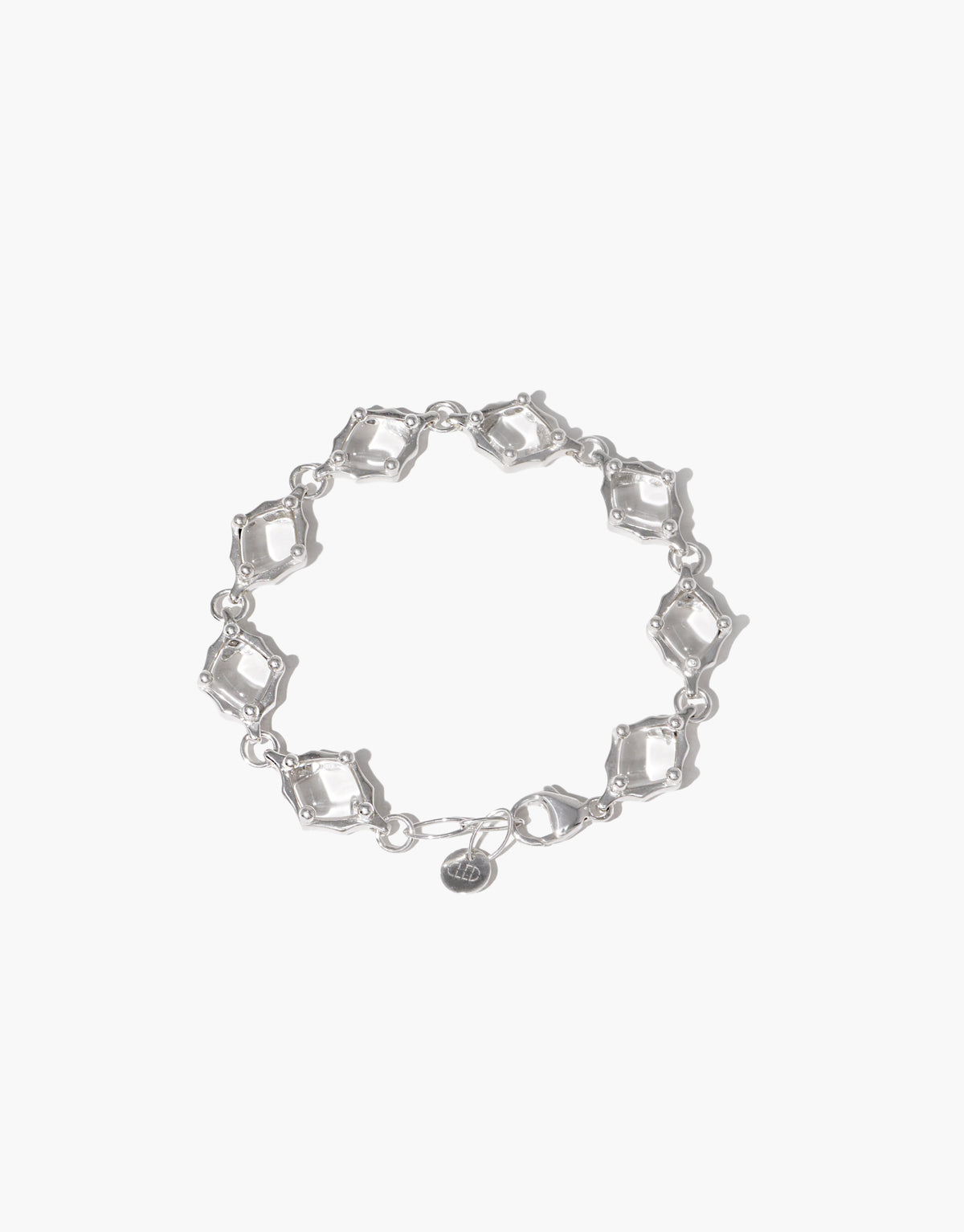 Cadence Bracelet in sterling silver, eight clear glass Eco Gems each set in its own scalloped silver frame around the wrist. Cadence Bracelet | Metal by CLED.