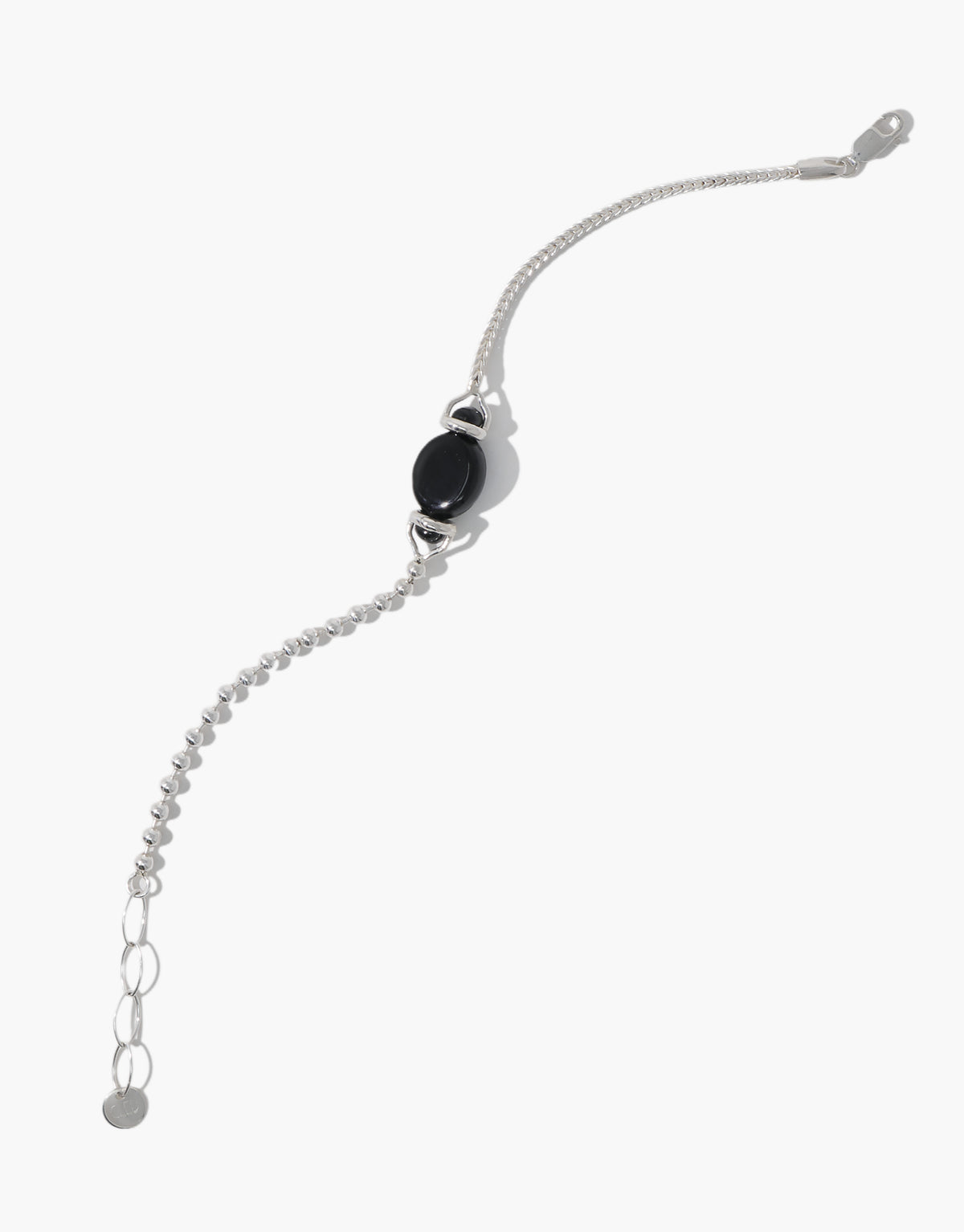 Picot Bracelet shown from another angle, the black basalt glass stone centered between two different sterling silver chains. Picot Bracelet by CLED.