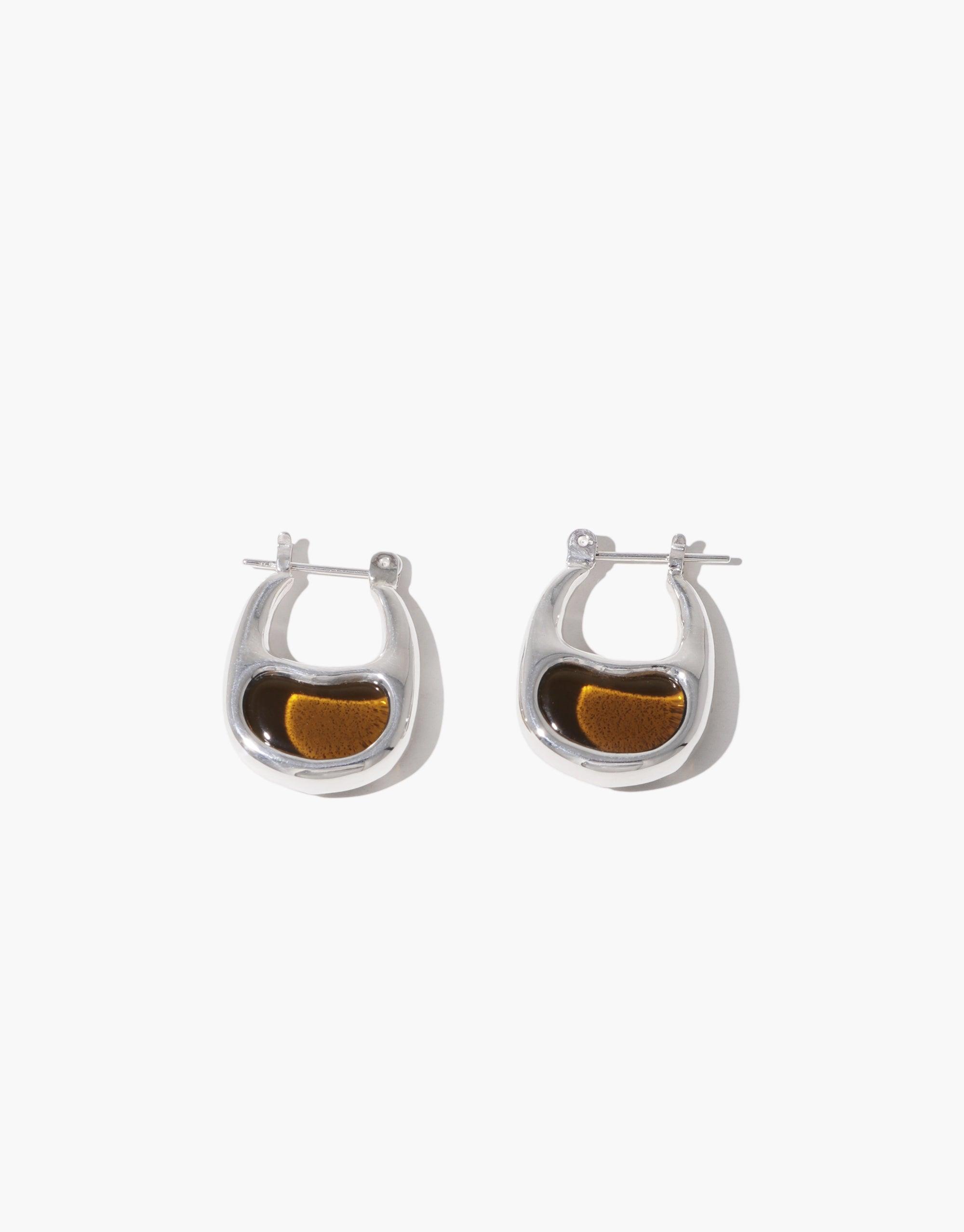 Elegant silver hoop earrings with unique bean-shaped design, featuring a warm amber-colored accent inside each hoop. Inspired by nature's organic forms. Bean Hoop Earrings | Small by CLED