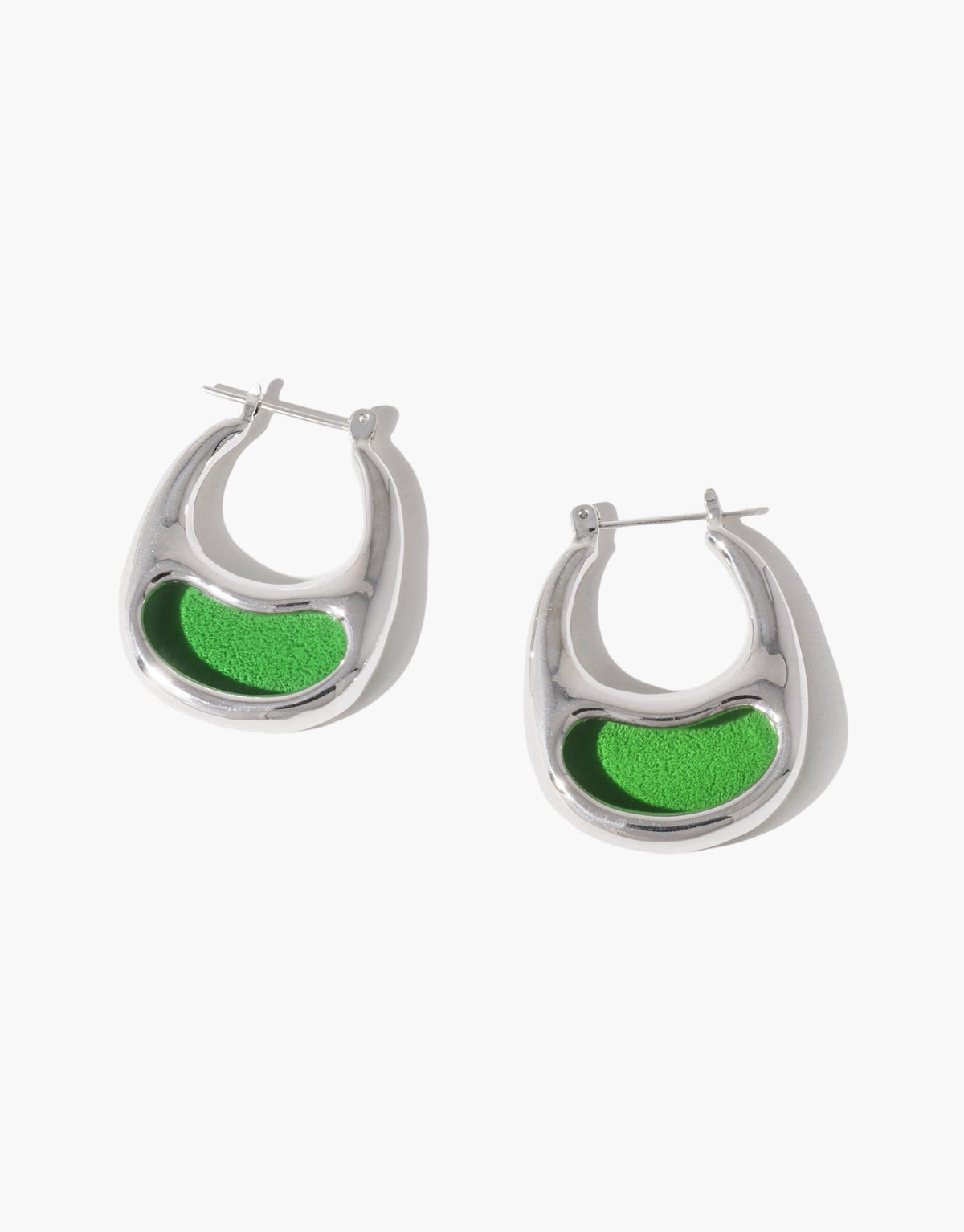 Large silver hoop earrings with curved shape and vibrant green enamel inlay, resembling organic bean pods. Nature-inspired jewelry design showcasing growth and transformation. Bean Hoop Earrings | Large. CLED