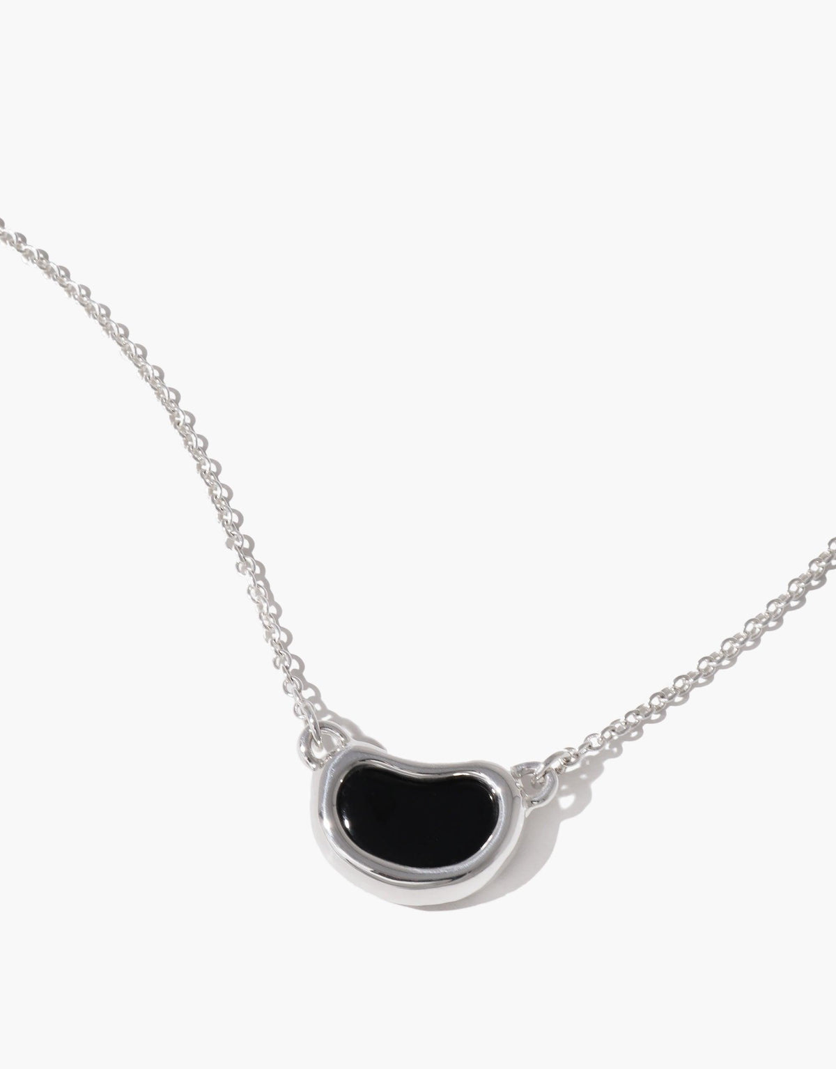 Elegant Bean Necklace featuring a sleek silver chain with a unique black bean-shaped pendant, showcasing nature-inspired design. Perfect accessory for a minimalist and organic look. Bean Necklace by CLED
