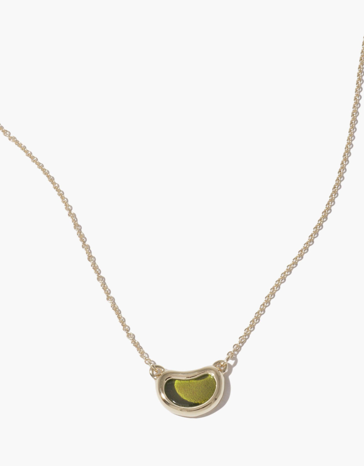 Elegant Bean Necklace featuring a delicate silver chain and unique bean-shaped pendant with green center, inspired by nature's organic forms. Perfect accessory for a subtle, sophisticated look. Bean Necklace by CLED