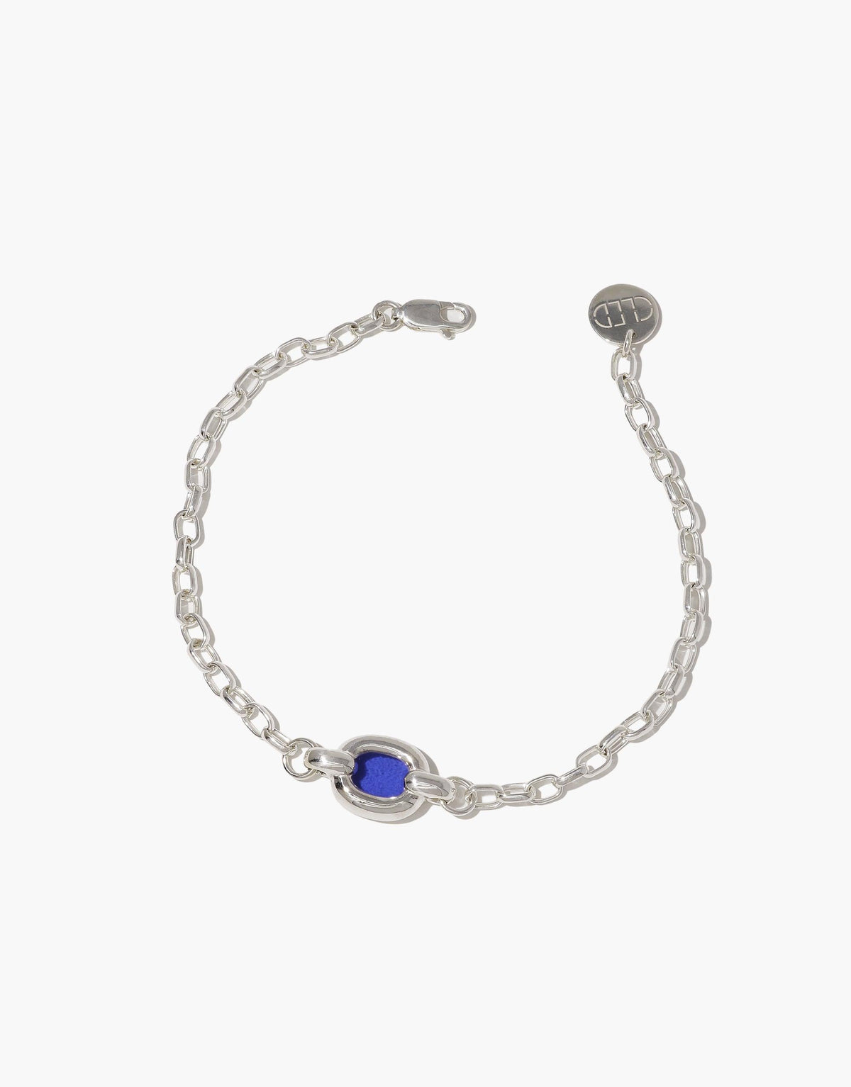 Elegant silver chain bracelet with a single blue bead centerpiece, showcasing minimalist design and sustainable craftsmanship. Core Loop Bracelet symbolizes unity and upcycling, perfect for everyday wear. CLED