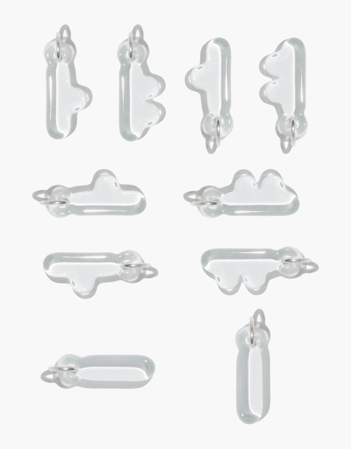 Various transparent glass letter charms in bubble-like shapes, featuring Korean Hangul and English alphabet designs. Eco-friendly jewelry pieces for personal expression and cultural celebration. Letter Charm | 한글 Hangul by CLED