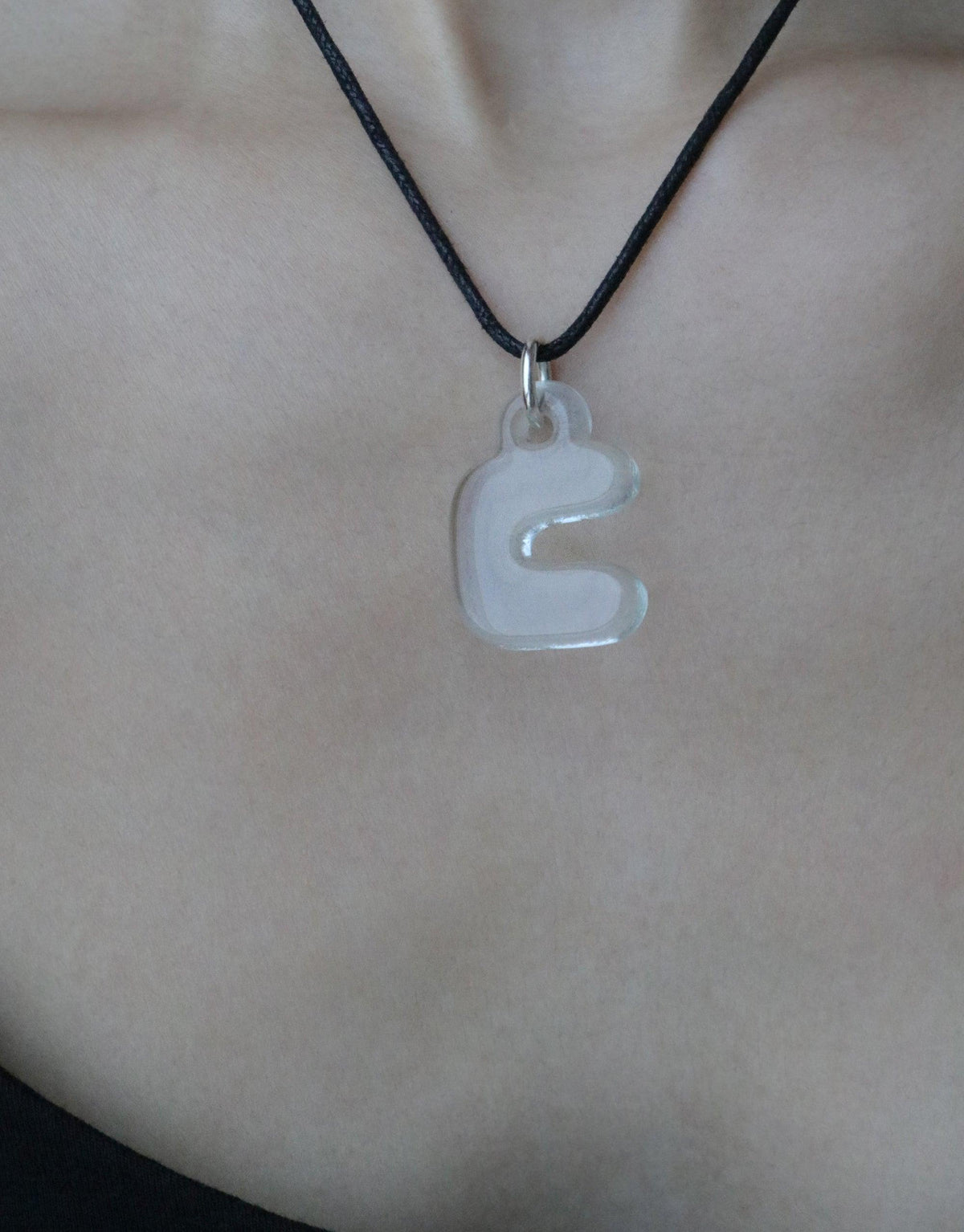 Bubble-shaped letter 'ㄷ' charm necklace on black cord, showcasing Korean Hangul alphabet. Eco-friendly jewelry made from recycled glass, celebrating cultural identity and personal expression. Letter Charm | 한글 Hangul by CLED