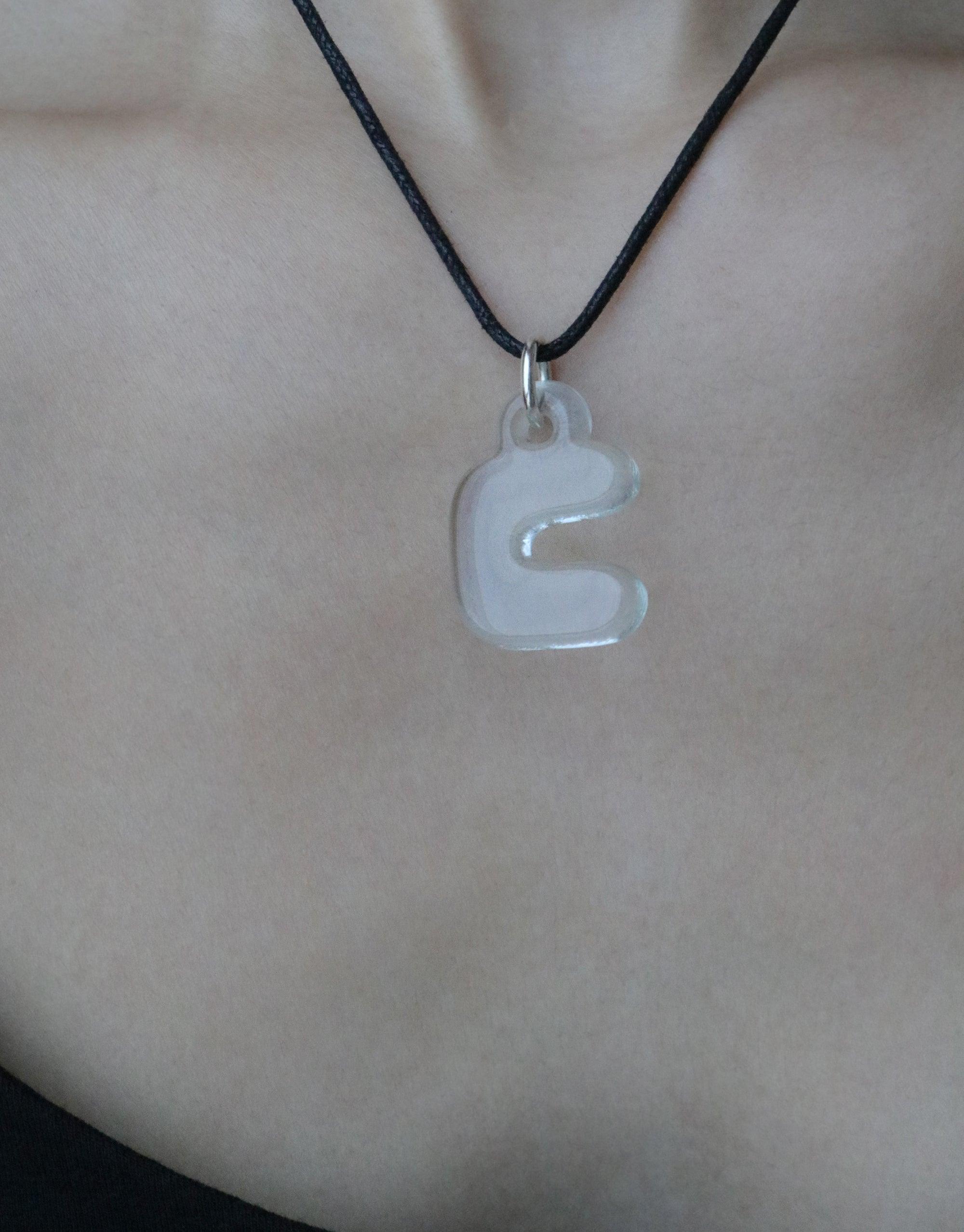 Bubble-shaped letter 'ㄷ' charm necklace on black cord, showcasing Korean Hangul alphabet. Eco-friendly jewelry made from recycled glass, celebrating cultural identity and personal expression. Letter Charm | 한글 Hangul by CLED