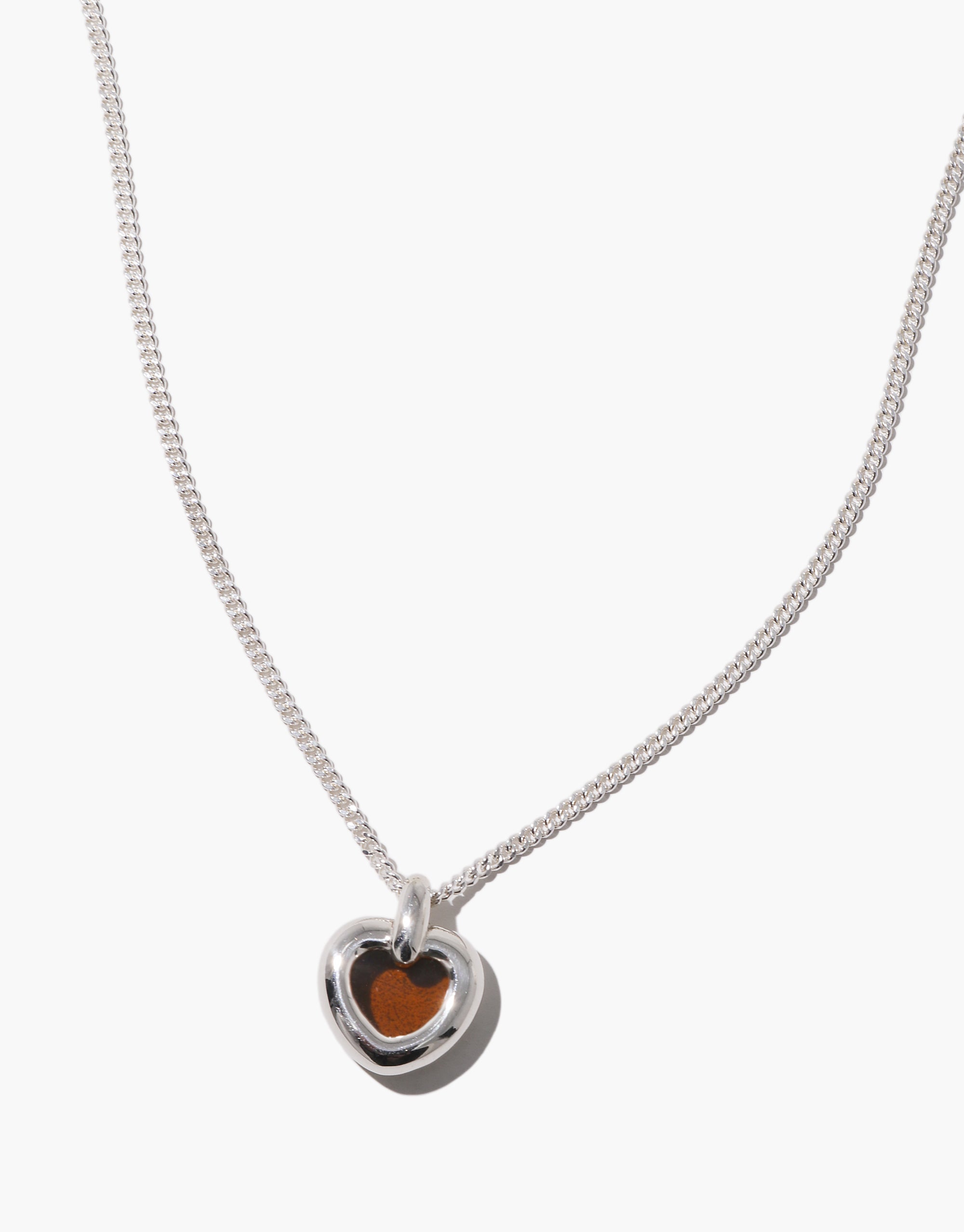 Core Heart Necklace | Small features a silver chain with a lightweight, softly rounded brown heart pendant, embodying CLED's eco-conscious design by transforming discarded glass into elegant jewelry.