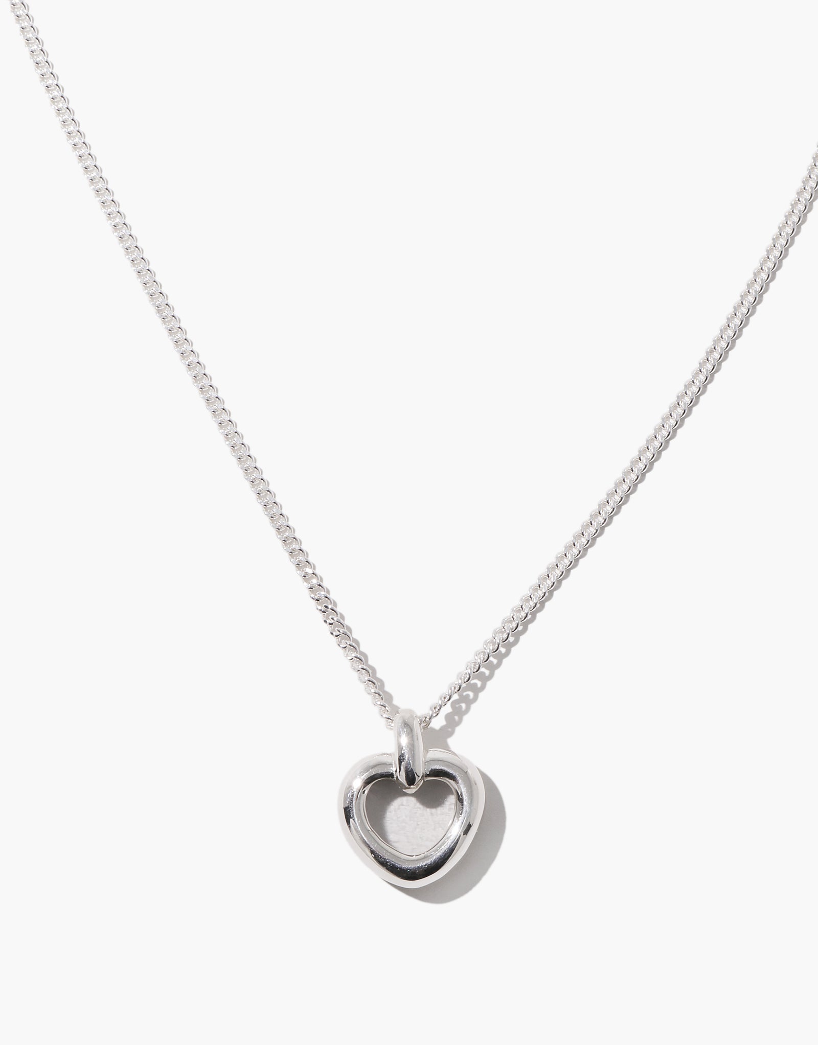 Core Heart Necklace | Small features a silver chain with a lightweight, softly rounded clear heart pendant, embodying CLED's eco-conscious design by transforming discarded glass into elegant jewelry.