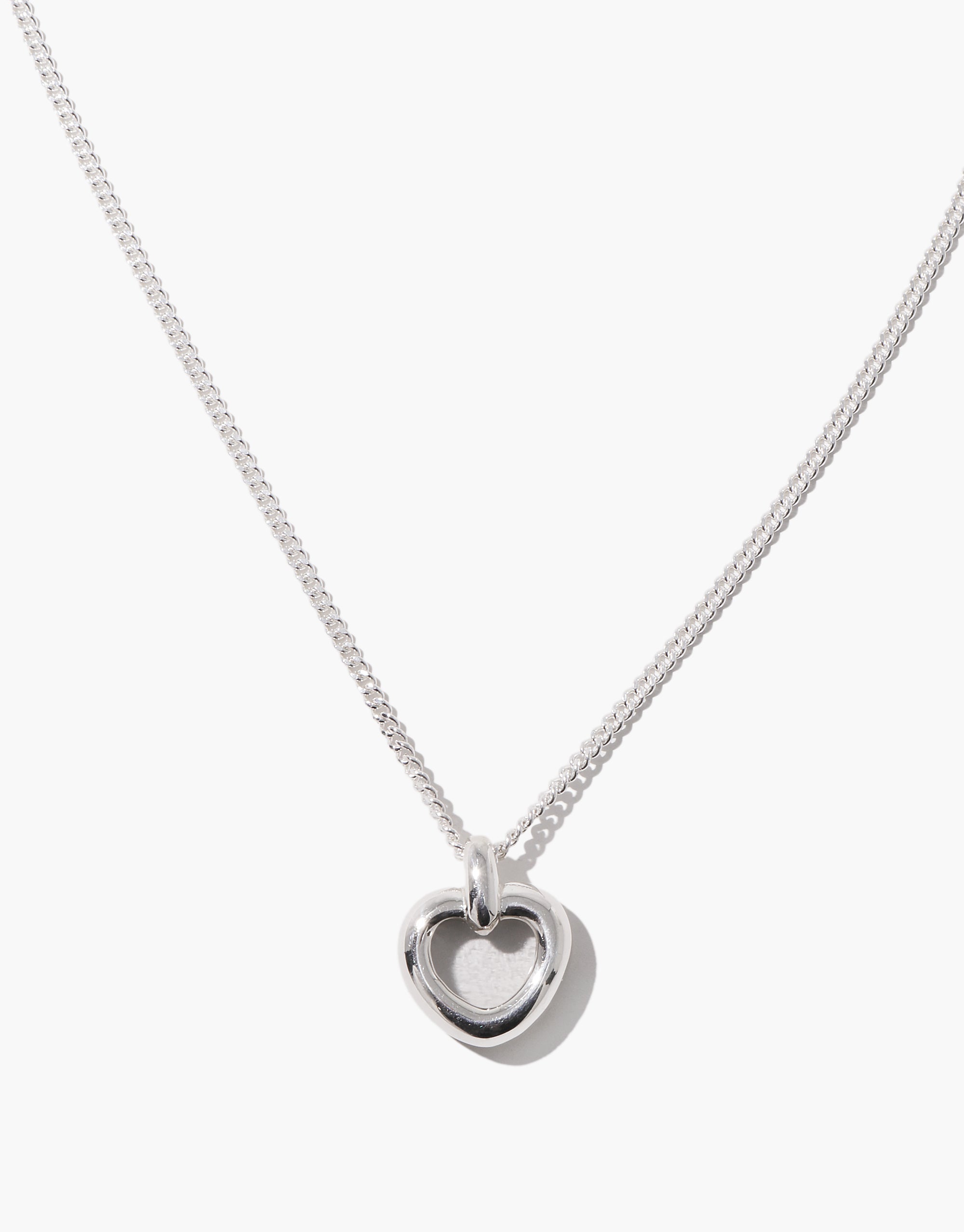 Core Heart Necklace | Small features a silver chain with a lightweight, softly rounded clear heart pendant, embodying CLED's eco-conscious design by transforming discarded glass into elegant jewelry.