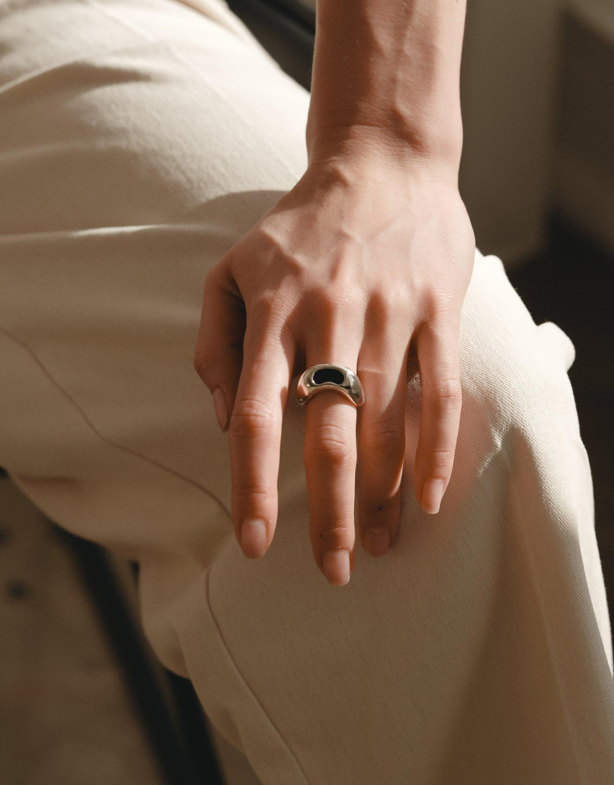 Bean Ring on hand showcasing organic shape inspired by legume plant, reflecting natural beauty and growth. Elegant design captures essence of nature's creativity, perfect for nature lovers. CLED Bean Ring.