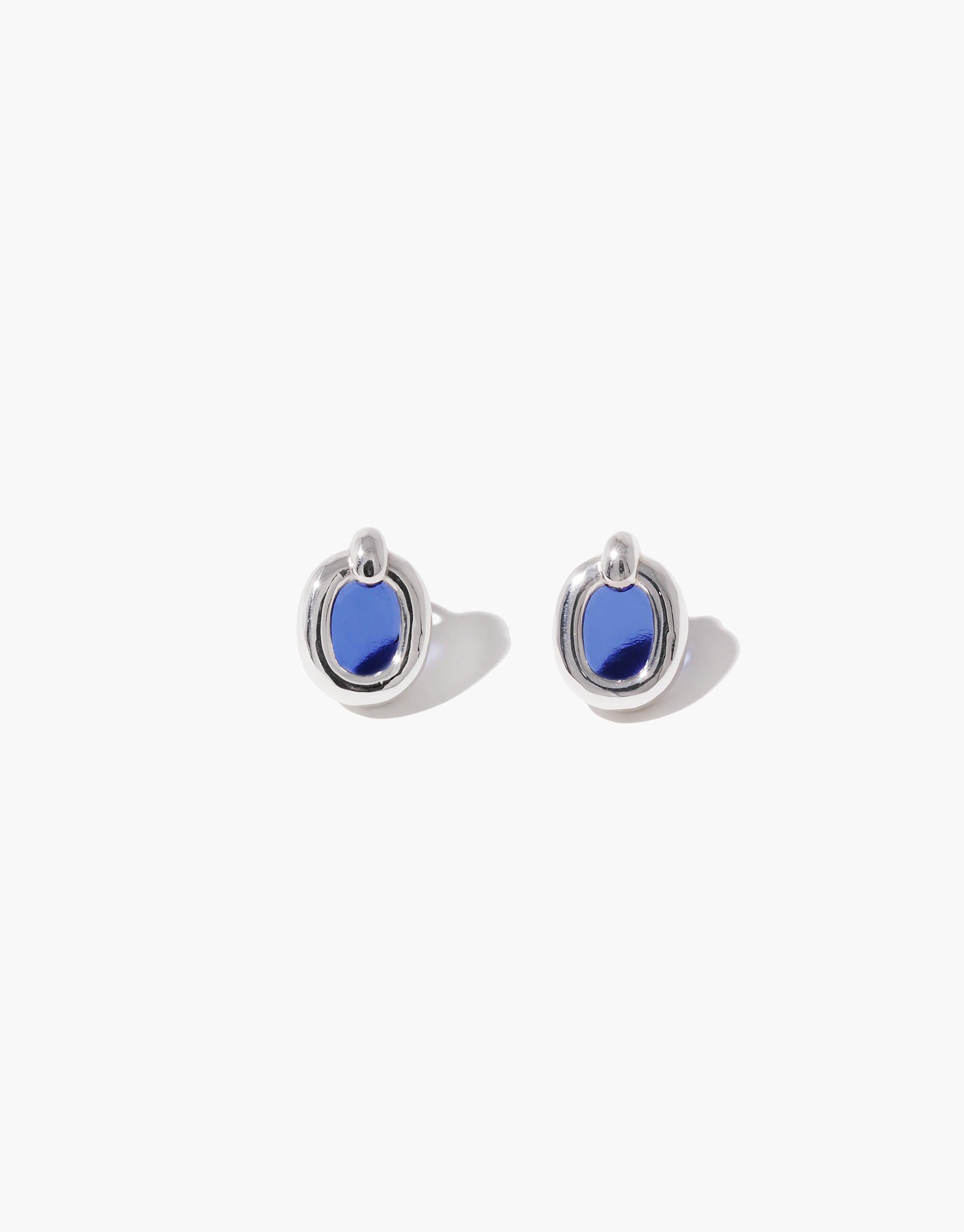 Small silver hoop earrings with vibrant blue oval-shaped accents, showcasing simple elegance and sustainable design. Core Loop Earrings | Small by CLED.