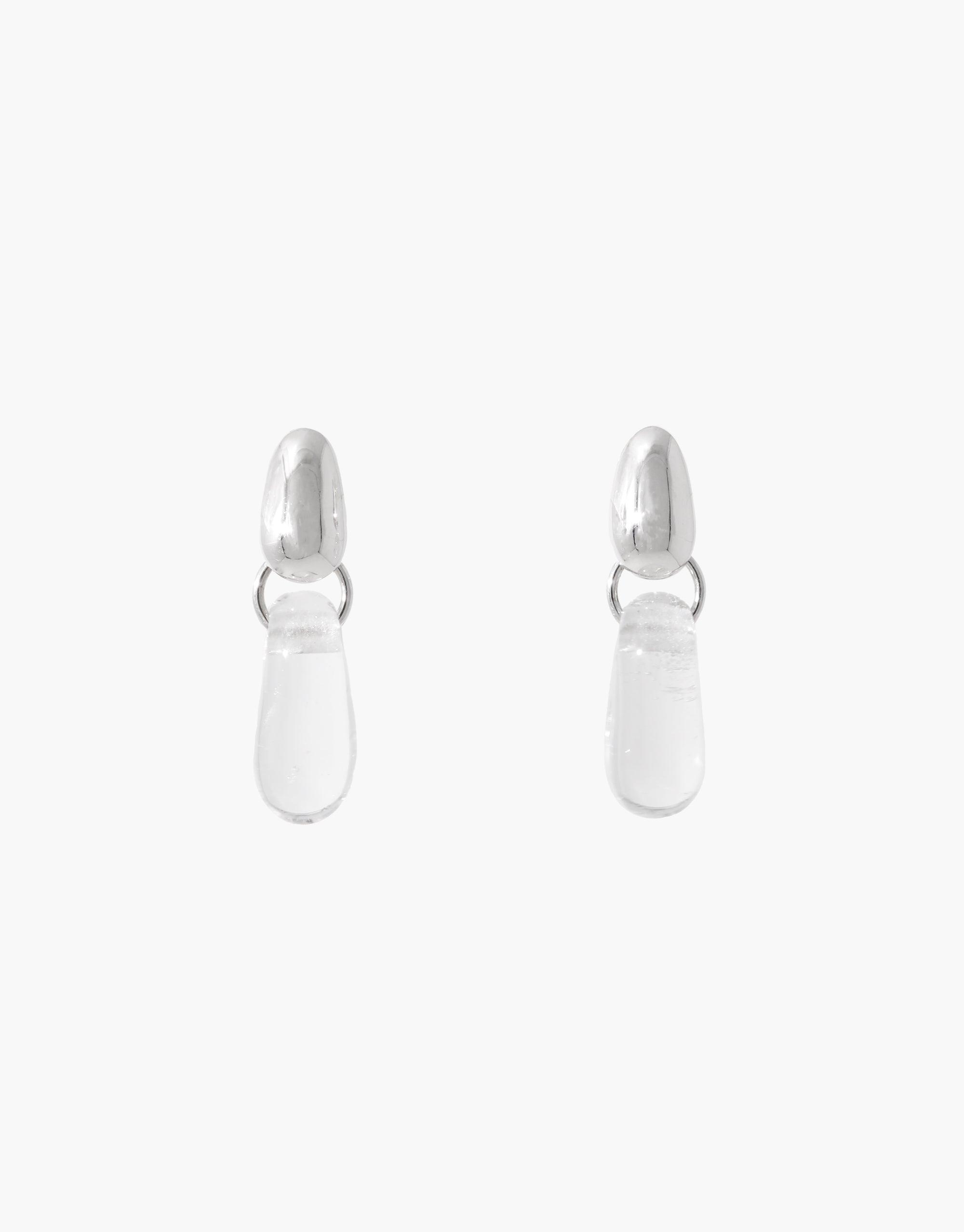 Elegant Drop Counts Earrings featuring oval posts and clear teardrop-shaped pendants. Minimalist design inspired by water, handcrafted from sterling silver or gold vermeil with upcycled eco glass. Sustainable jewelry by CLED