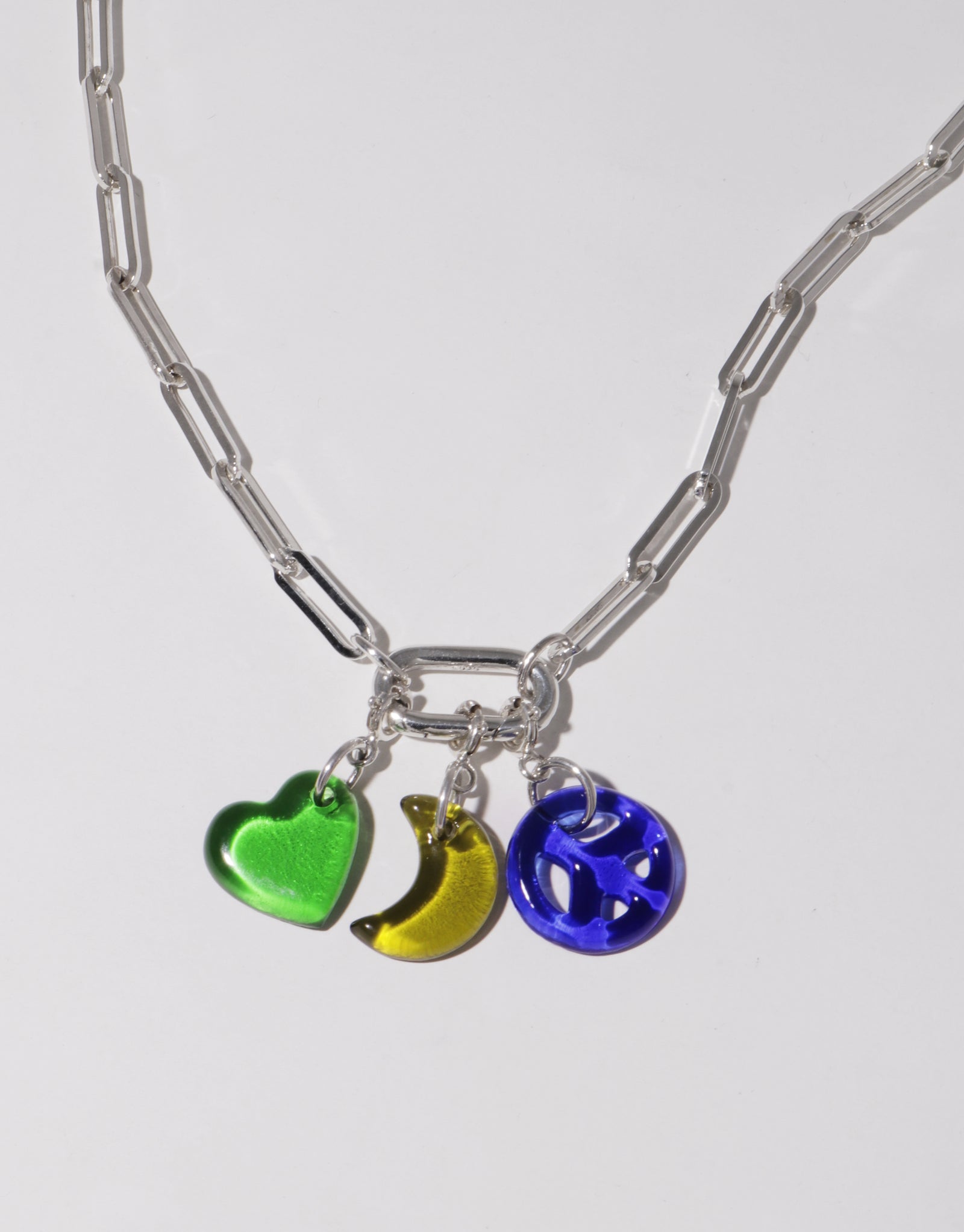 Stylish silver chain necklace with colorful glass charms including green heart, yellow crescent moon, and blue sphere. Versatile Icon Chain Necklace | D for customizable jewelry looks. Eco-friendly fashion accessory. CLED