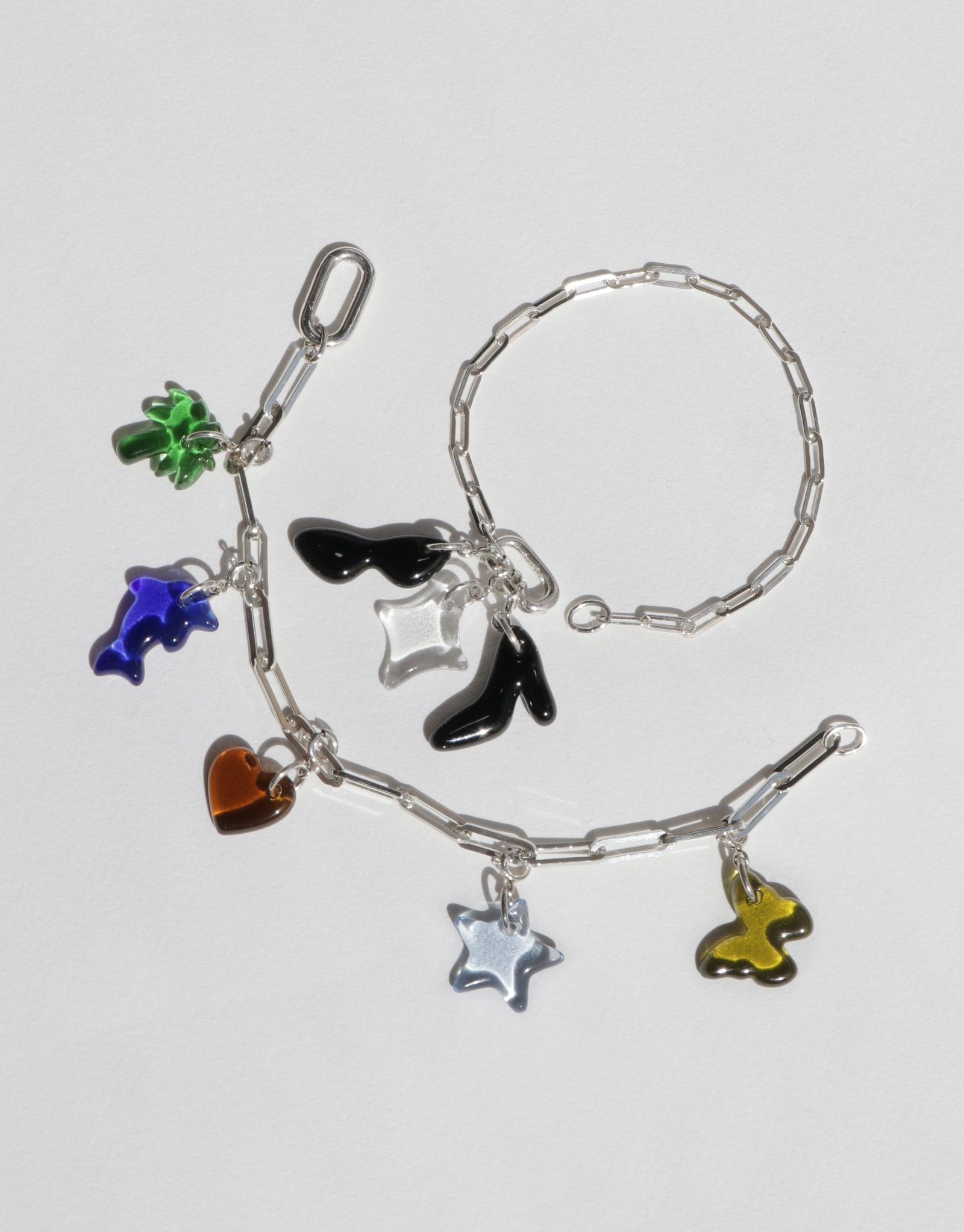 Silver chain bracelet with colorful charms including clover, dolphin, sunglasses, heart, and star. Customizable accessory for creating a unique style. Icon Chain Bracelet | D by CLED