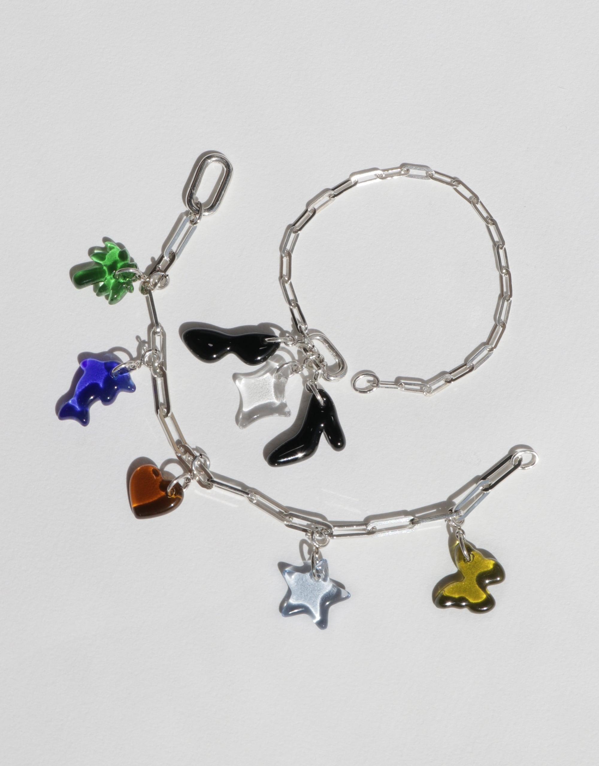 Silver chain bracelet with colorful charms including clover, dolphin, sunglasses, heart, and star. Customizable accessory for creating a unique style. Icon Chain Bracelet | D by CLED