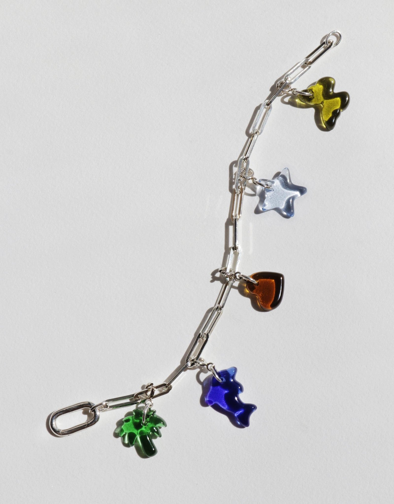 Silver chain bracelet with colorful glass charms including butterfly, star, heart, and flower shapes. Customizable accessory for creating unique styles. Icon Chain Bracelet | D by CLED