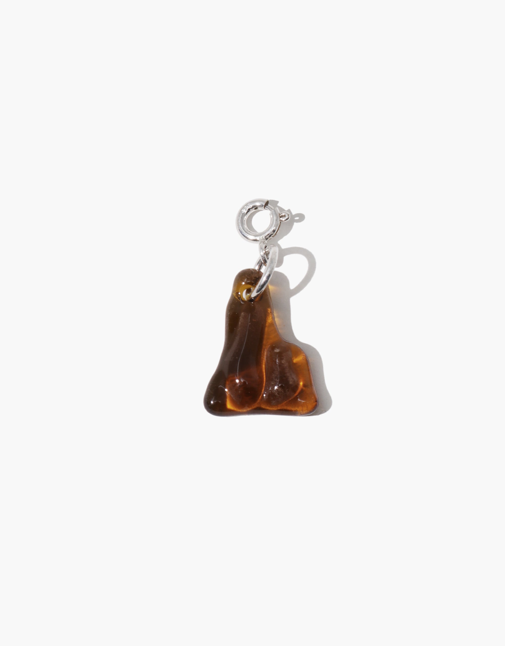 Amber rock mountain charm on a white background