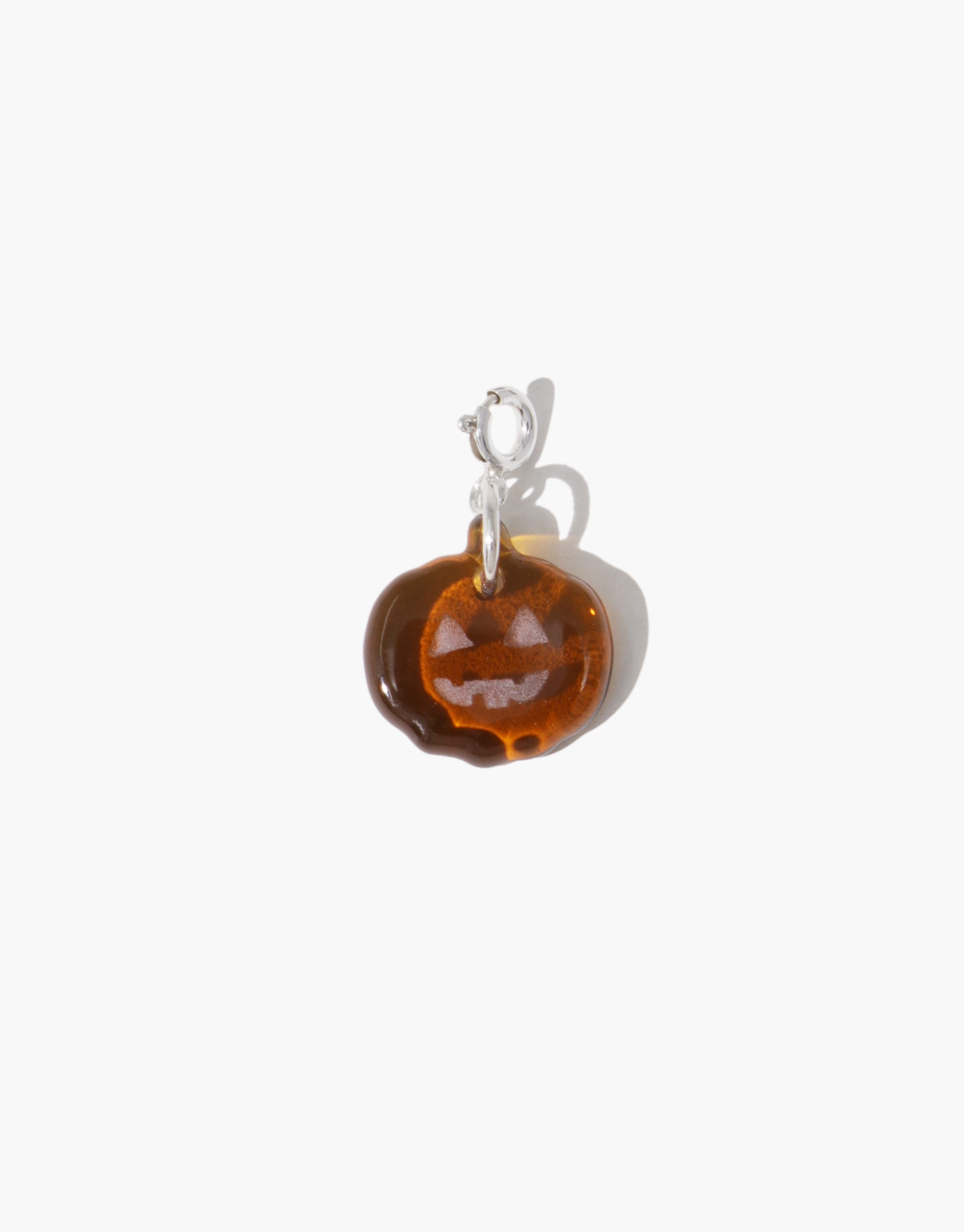 Amber pendant with silver bail on a white background