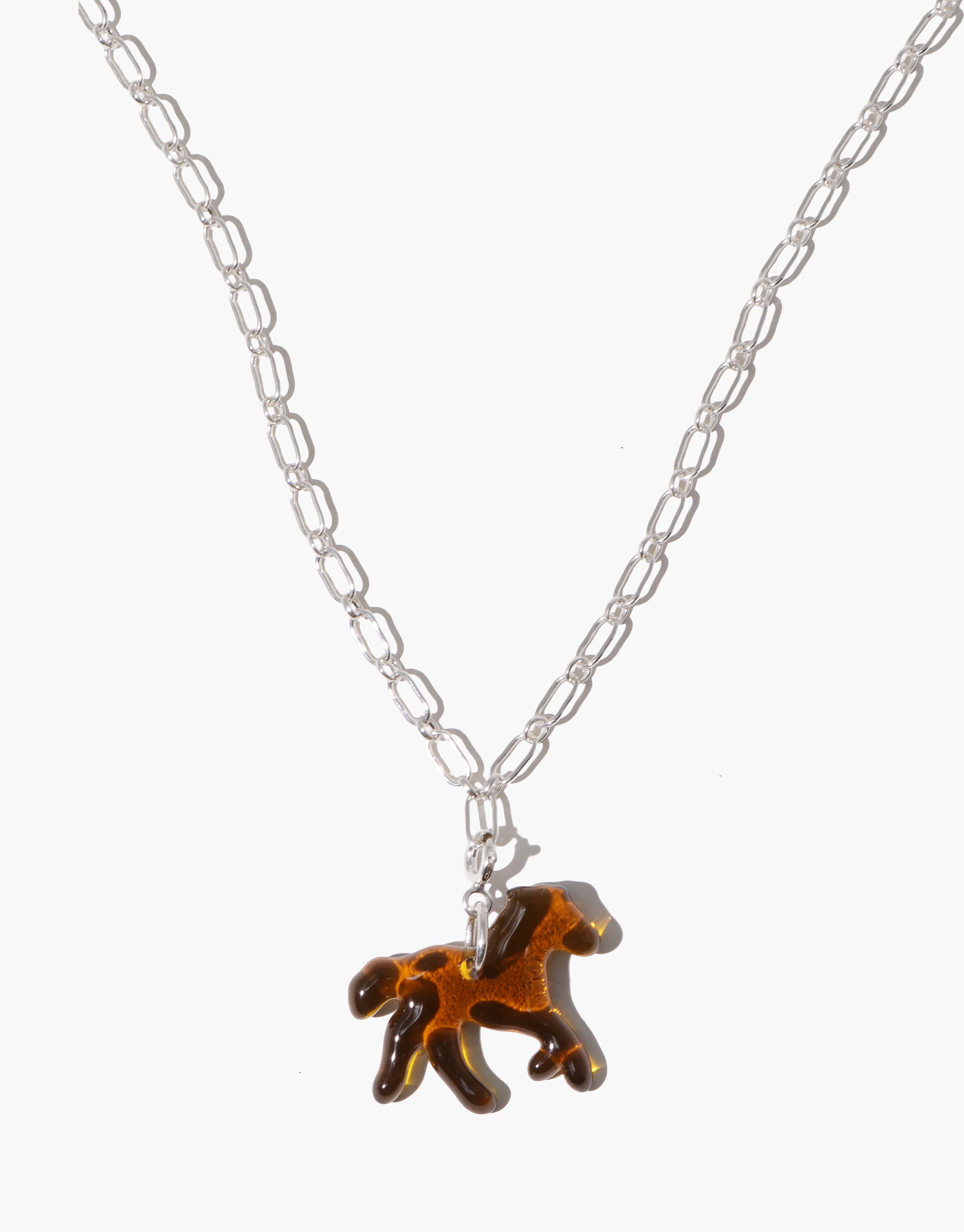 Necklace with a horse shape icon charm in brown glass and silver clasp on a white background